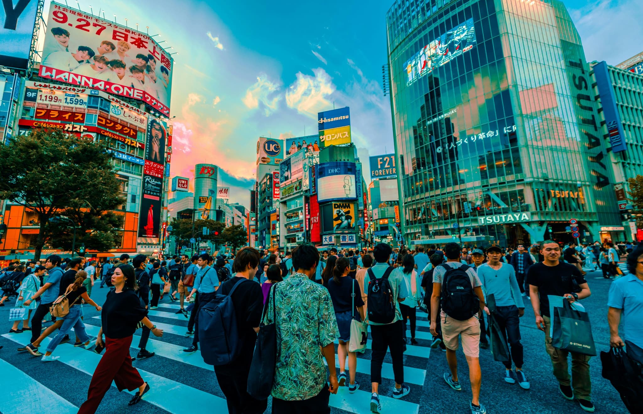 Crowds crossing the famous Shibuya Scramble Crossing in Tokyo at dusk