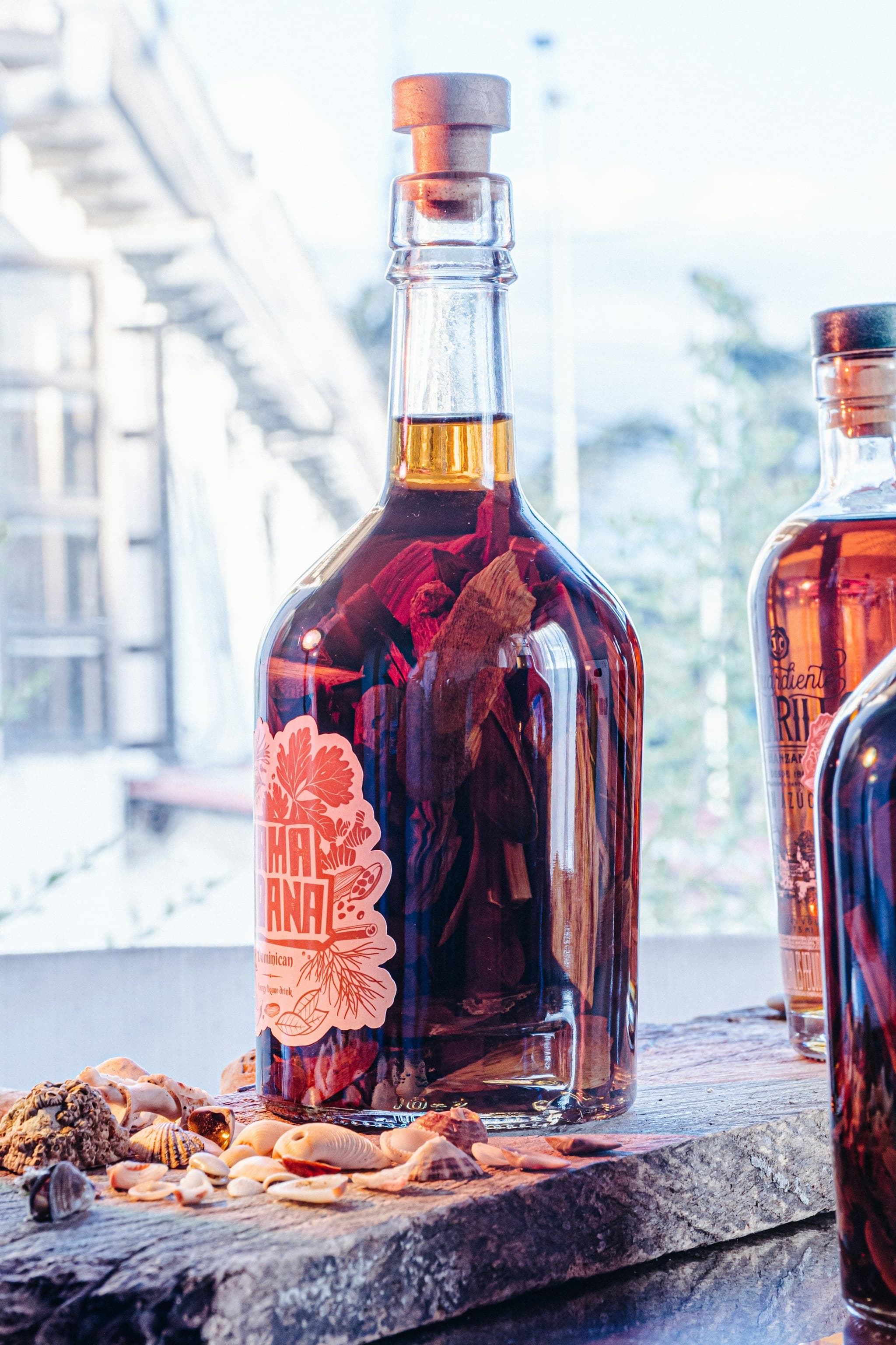 Bottles of liquor steeped with bark and herbs on a table