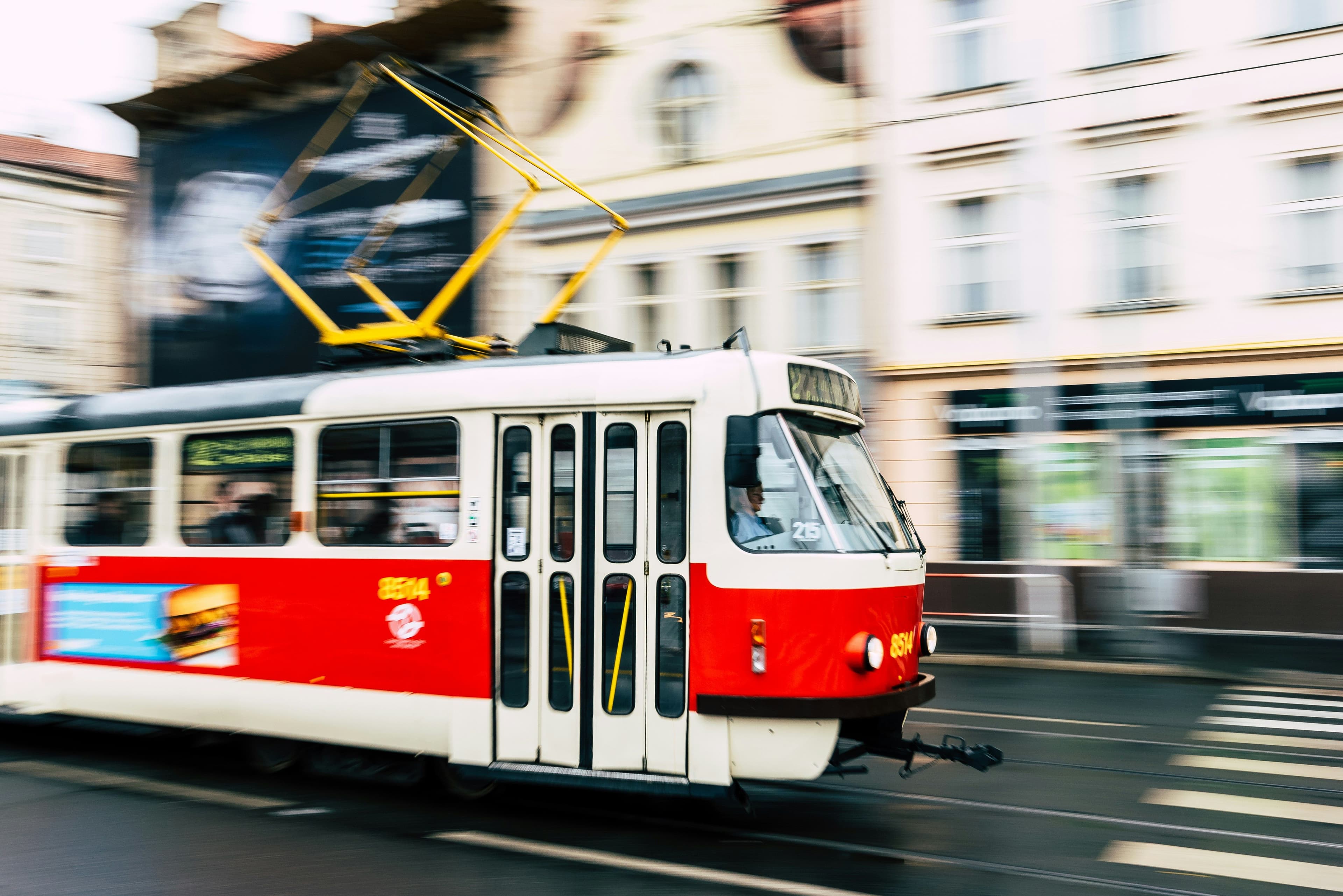 A blurred picture of a red tram in the city of prague