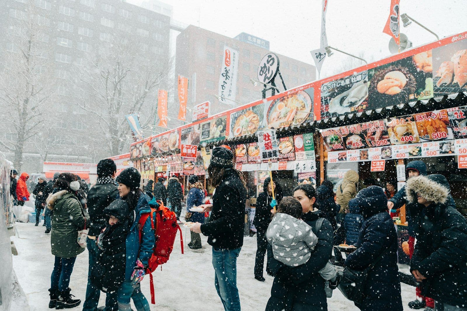Crowds gather among lit-up snow and ice sculptures at the Sapporo Snow Festival in Hokkaido, Japan.