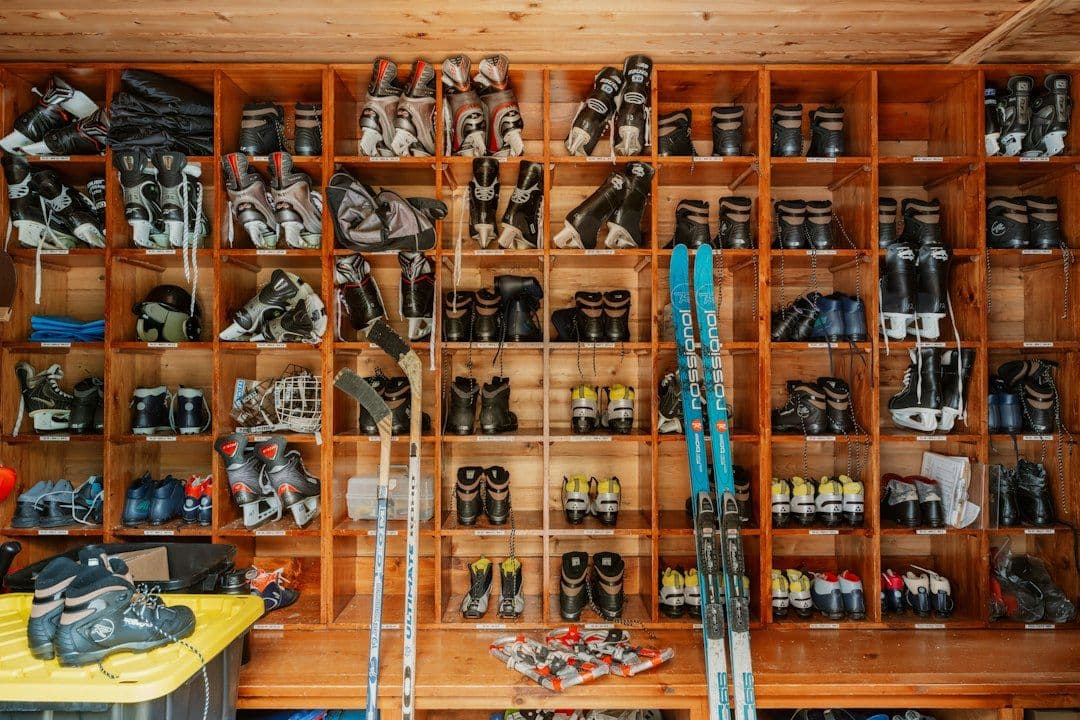 Ski boots and rental equipment lined up on a wall.