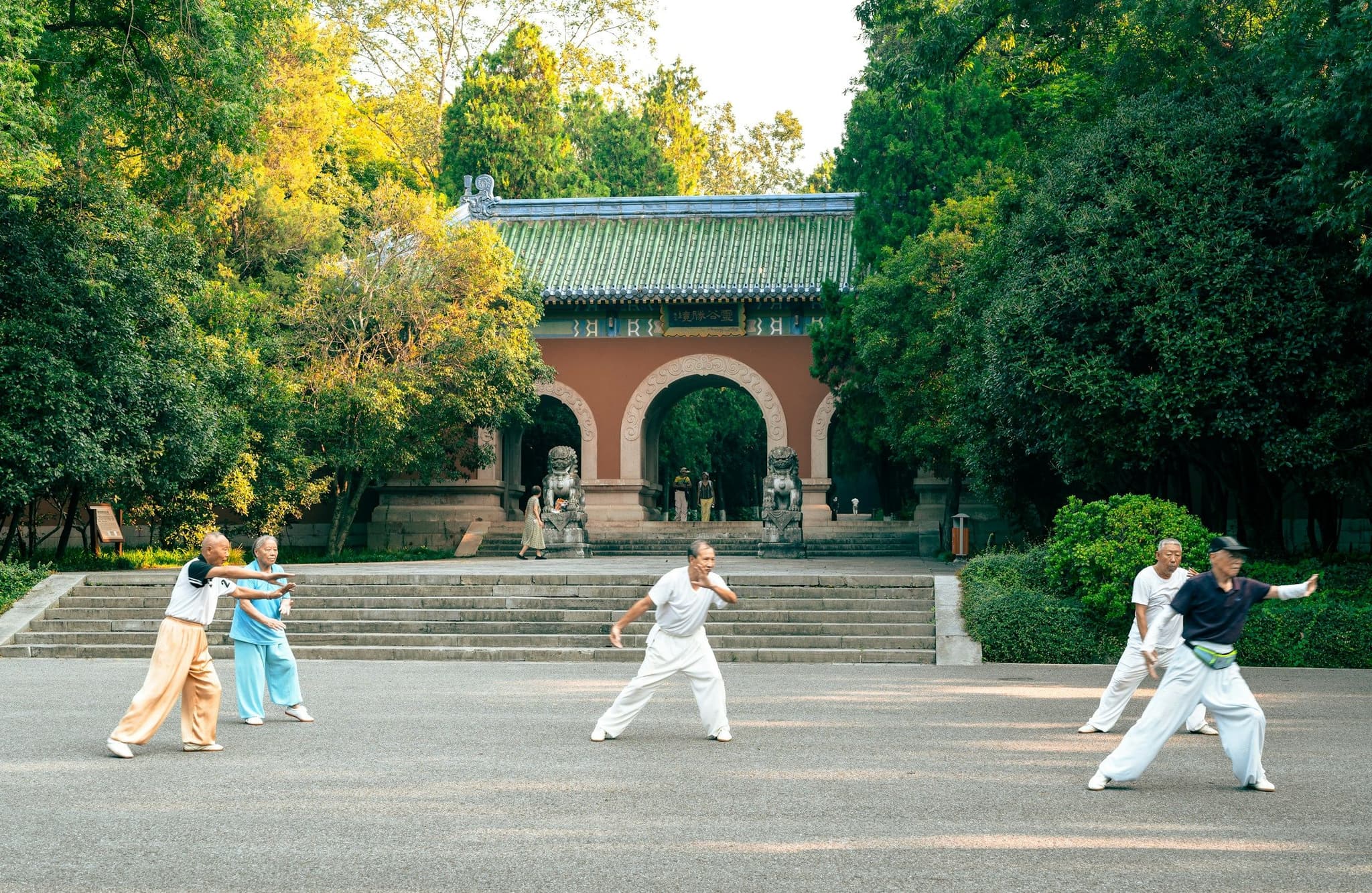 People practising tai chi in a park at Linggu Temple, Nanjing
