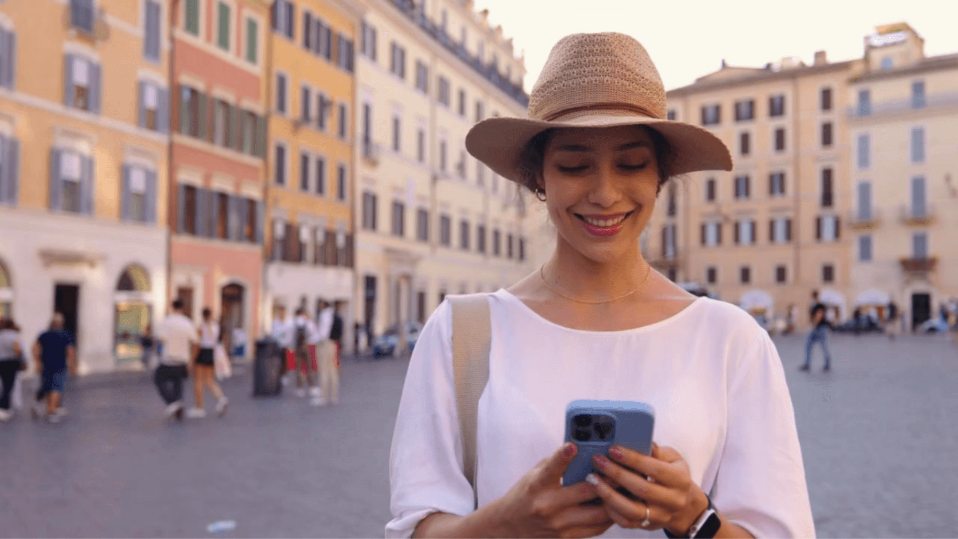 Girl holding phone walking through street