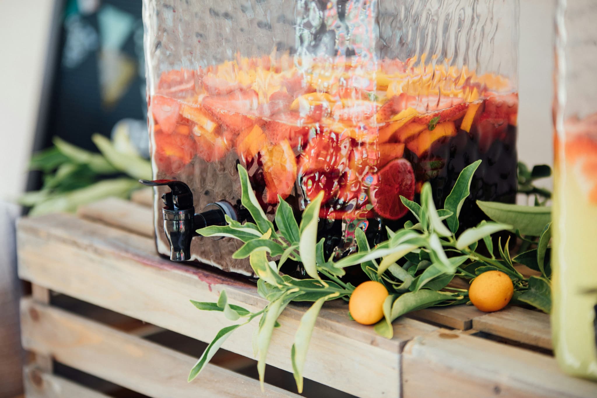 A big jar of red sangria with oranges