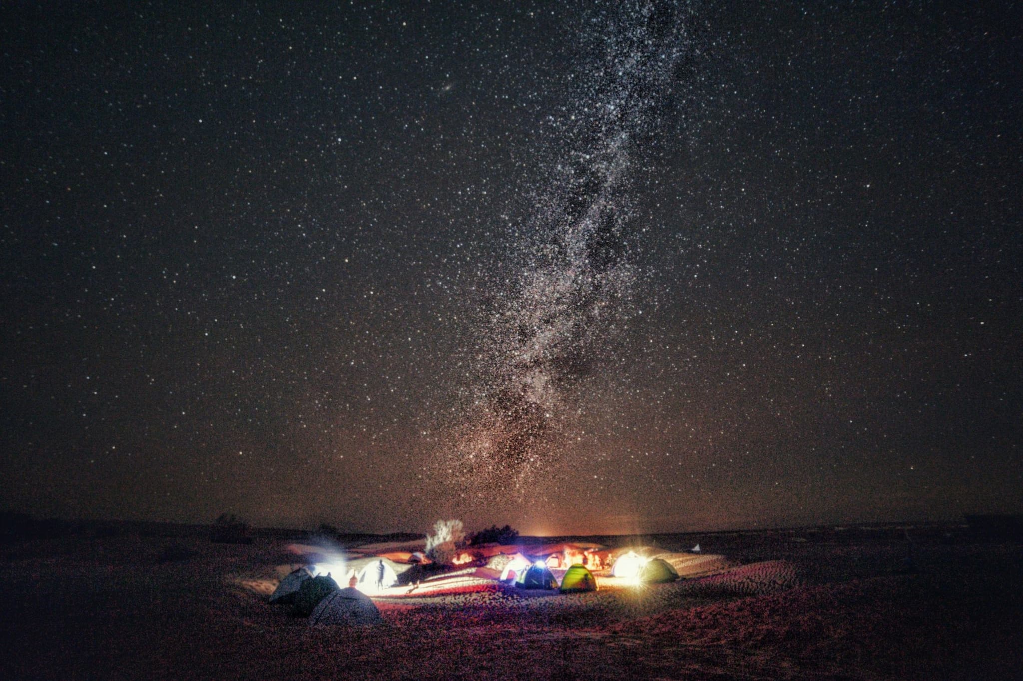 A campfire burning in the desert at night