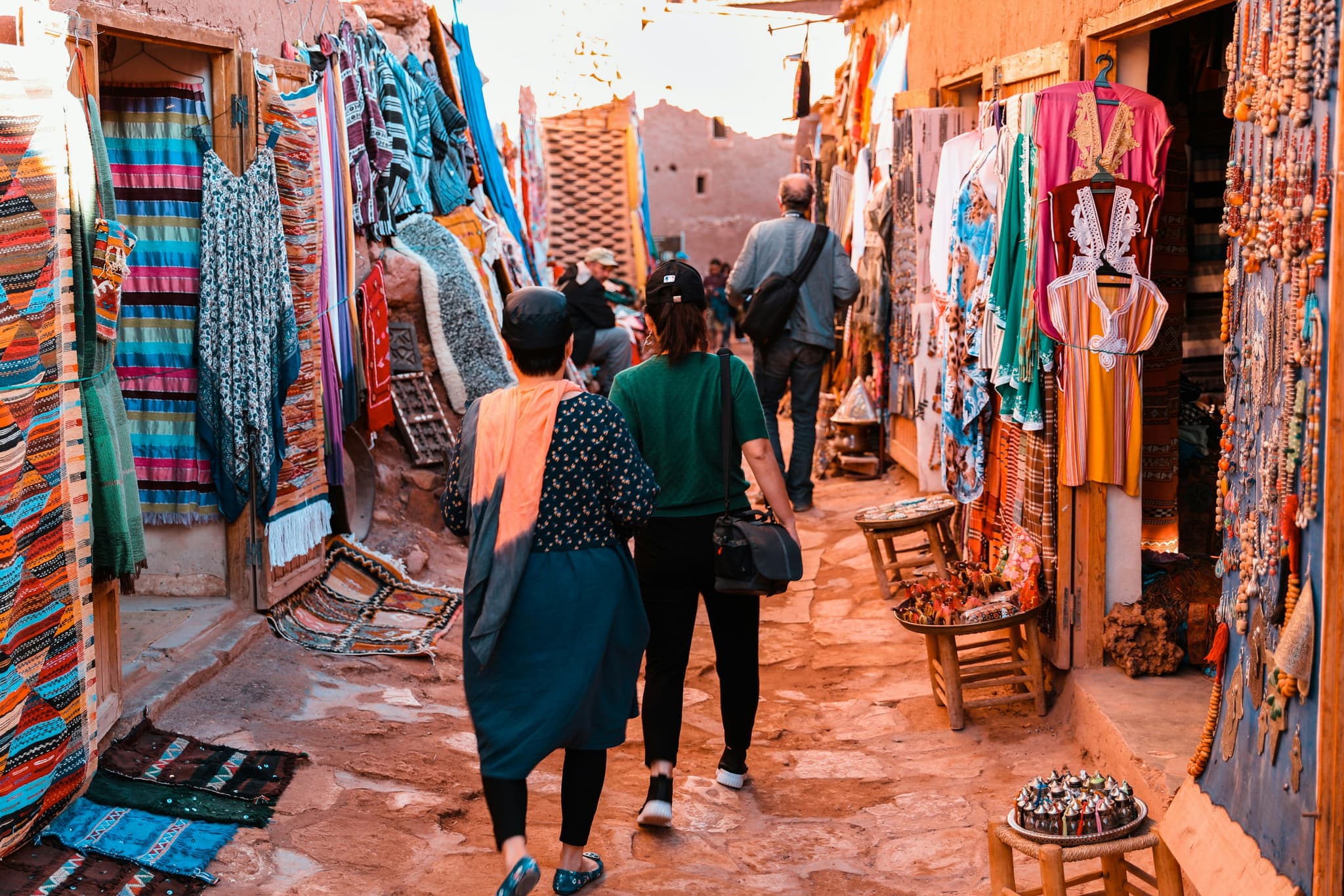 Two people walking in a market in morocco