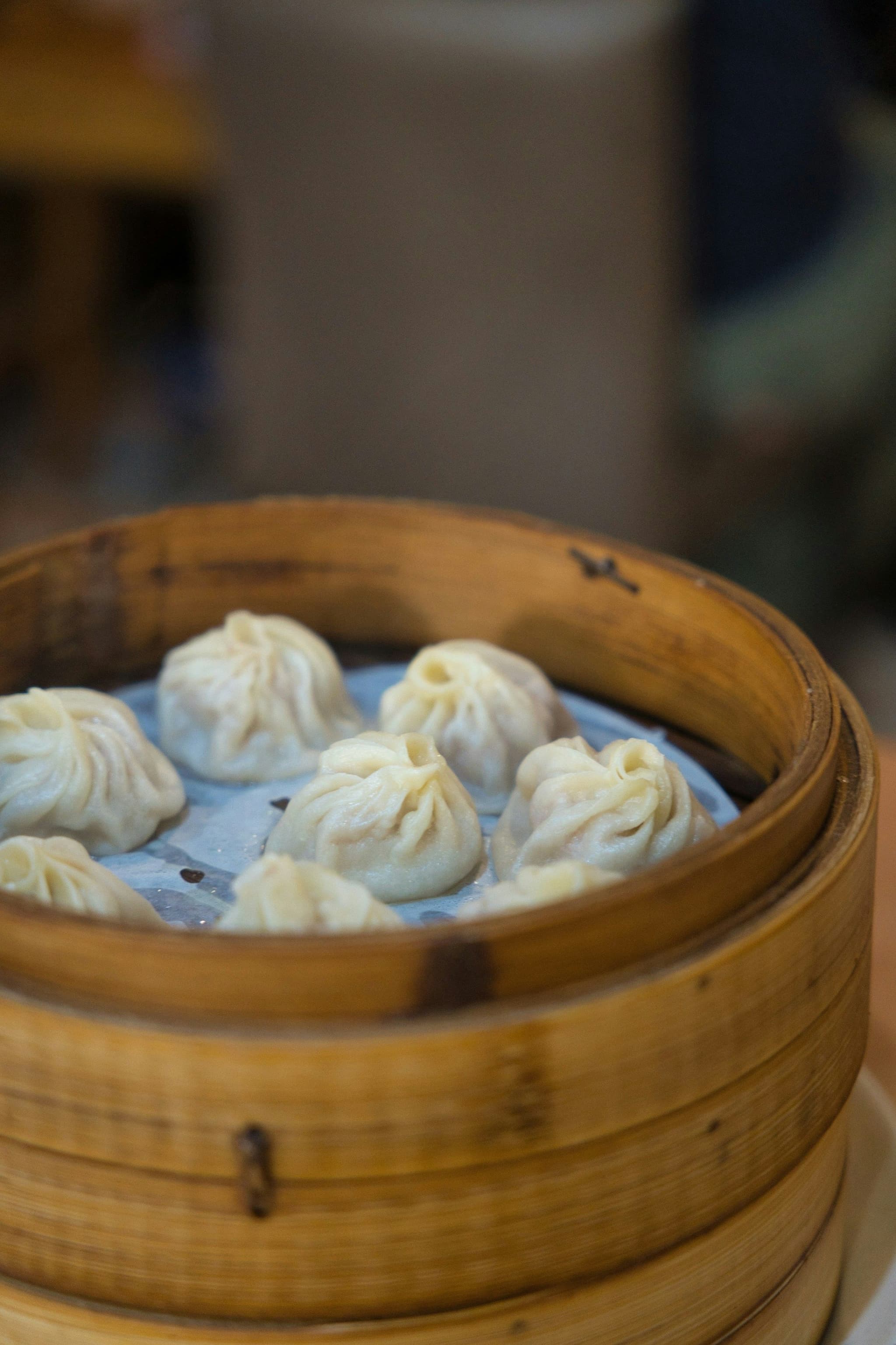Soup dumplings in a wooden steamer basket