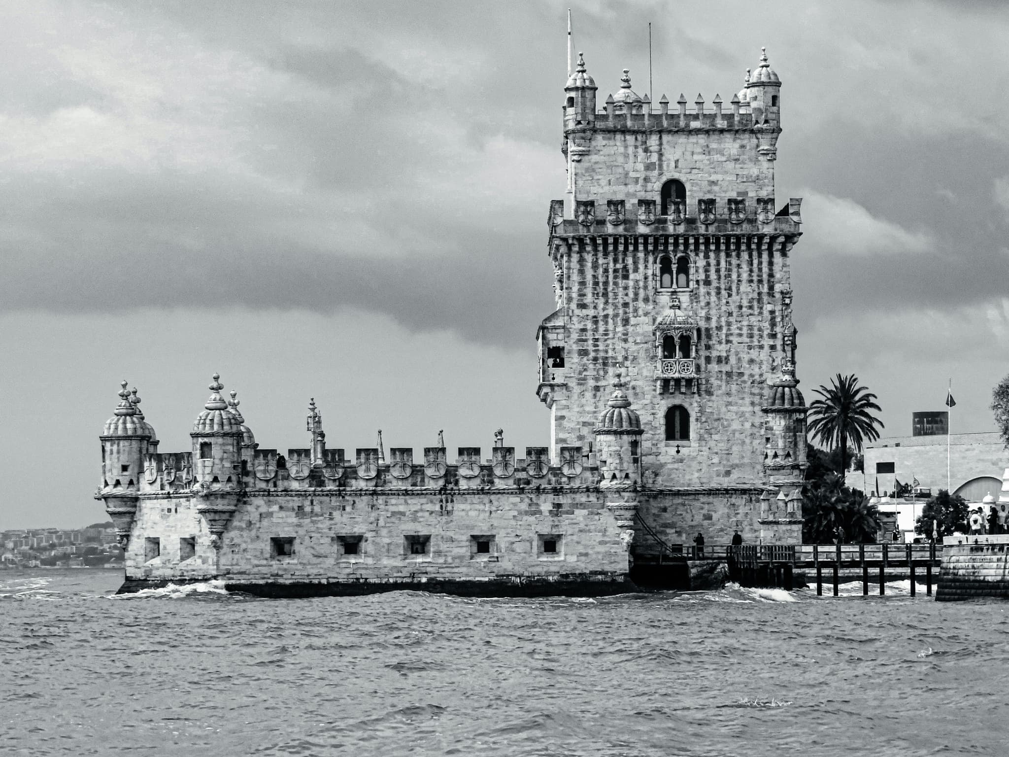 Old black and white of the Belém Tower in Portugal by the water