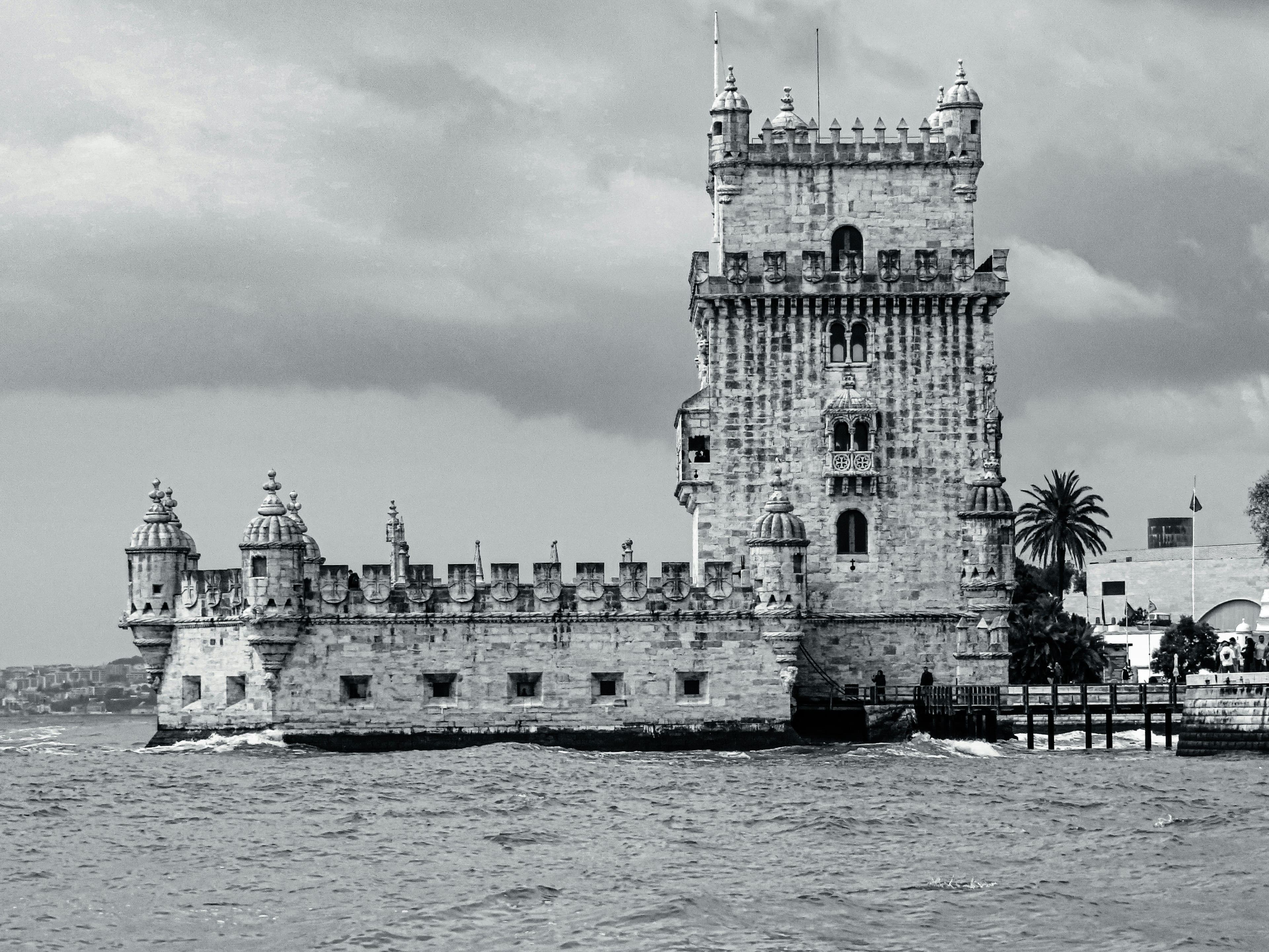 Old black and white of the Belém Tower in Portugal by the water
