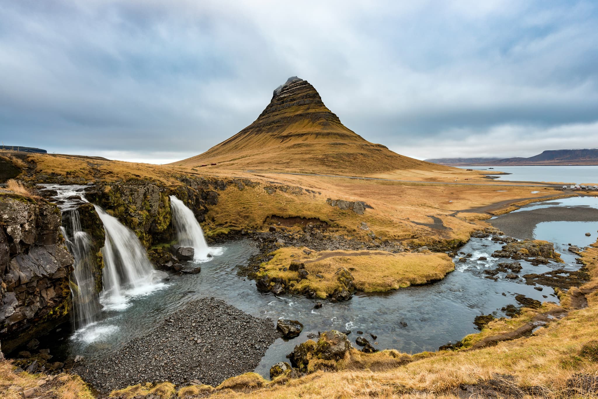 The príhnúkagígur volcano in Iceland and waterfalls on a cloudy day