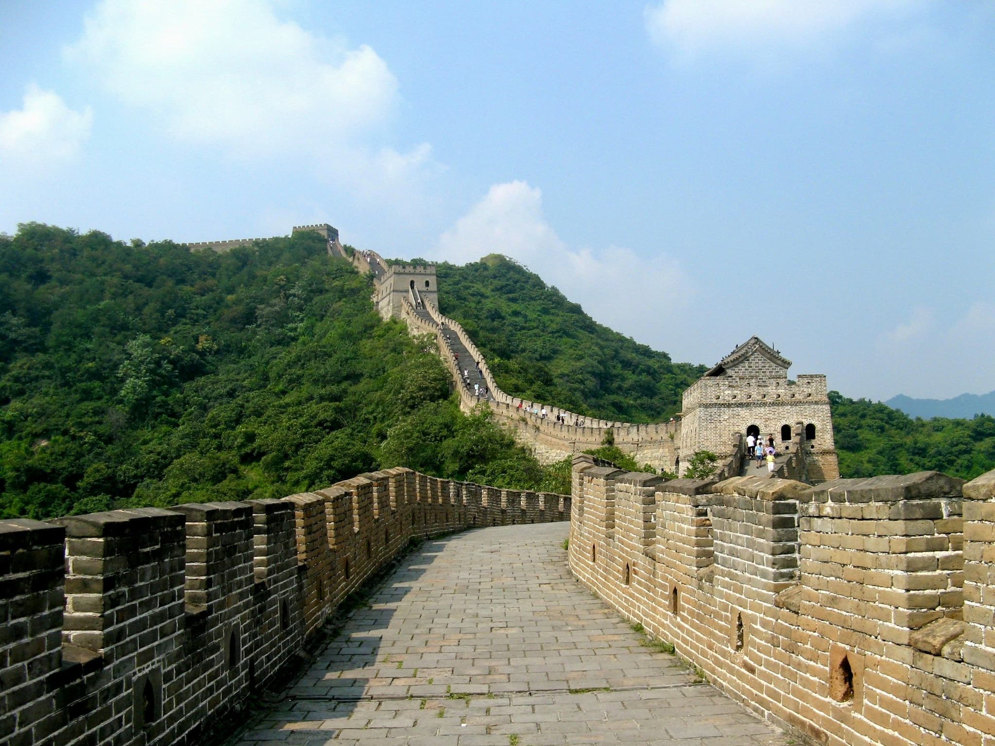 The Great Wall of China winding over hills on a clear day