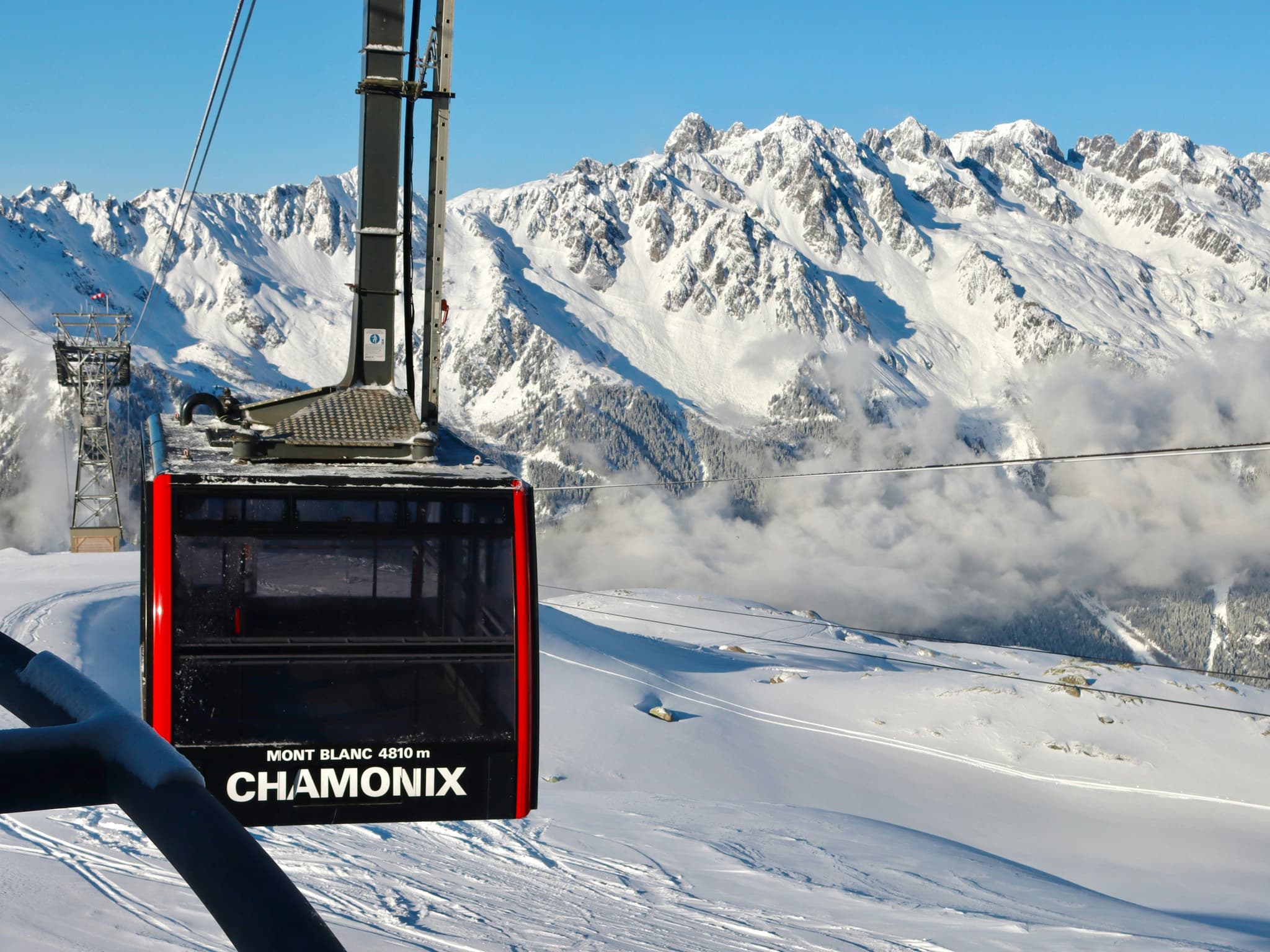 Cable car above snow-capped peaks in Chamonix