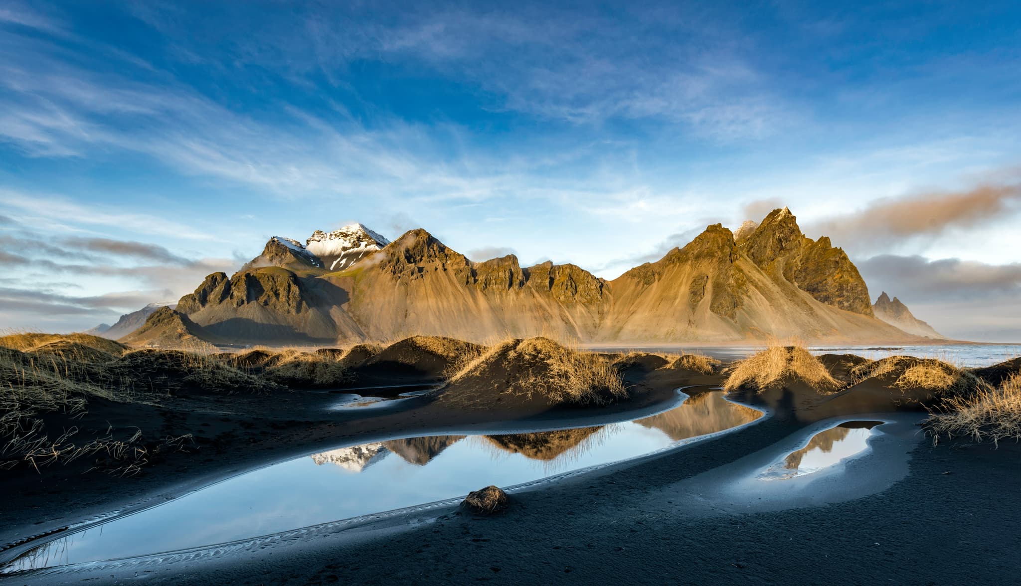 Vestrahorn mountain reflected into the water below