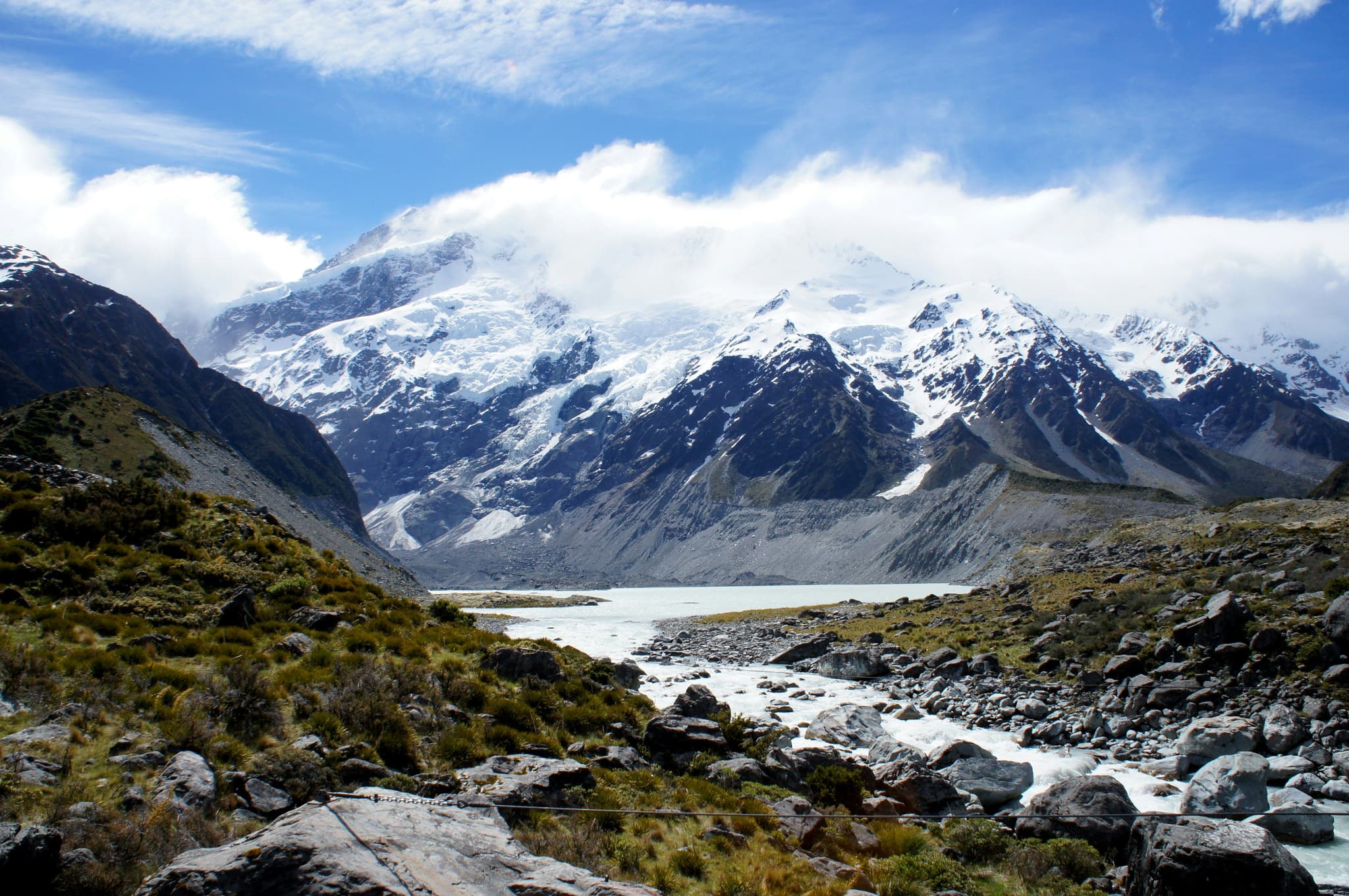 Stones and mountains with snow peaks in Hooker Valley