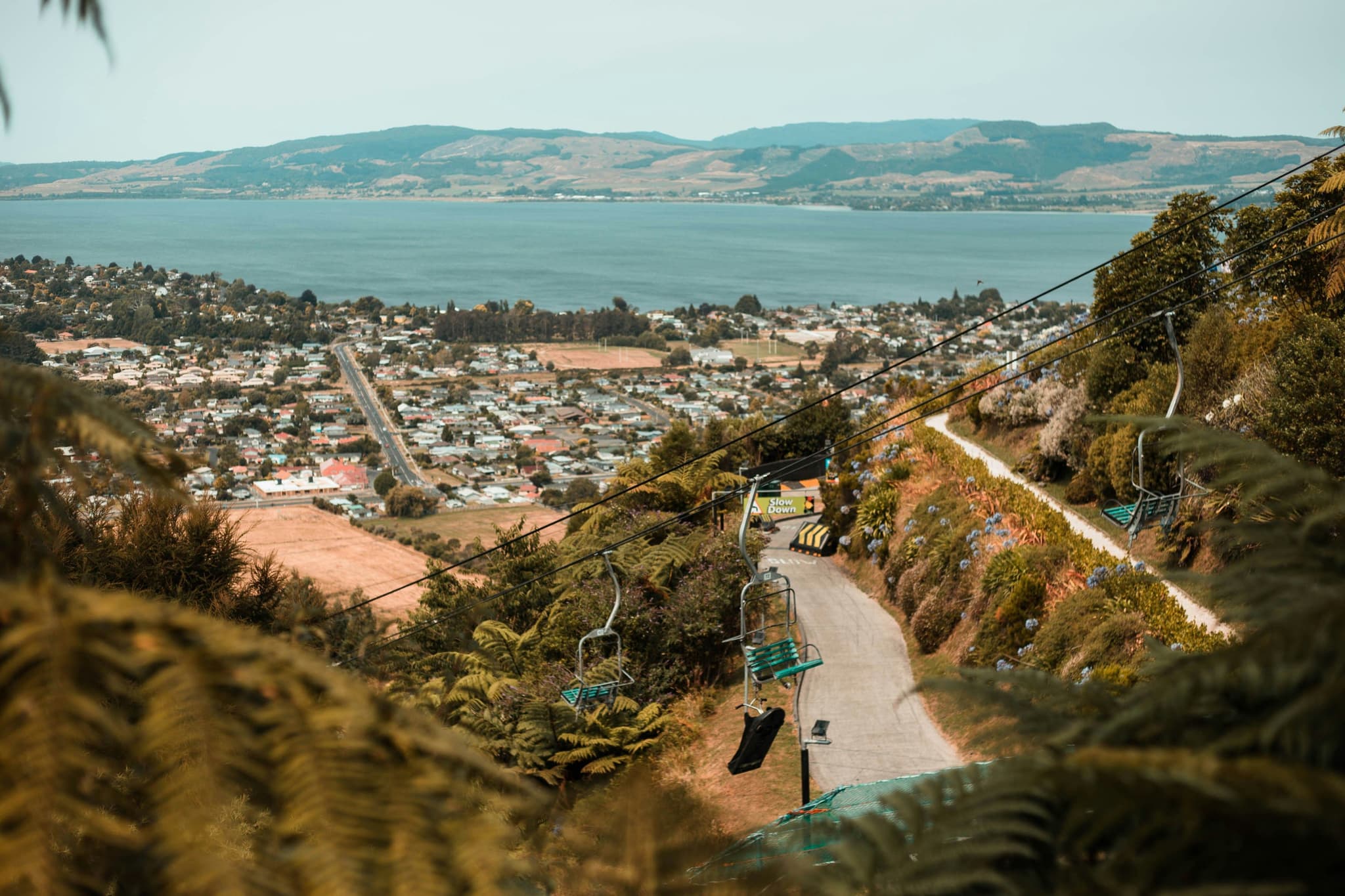 view of Rotorua from above, mountains, city and lake