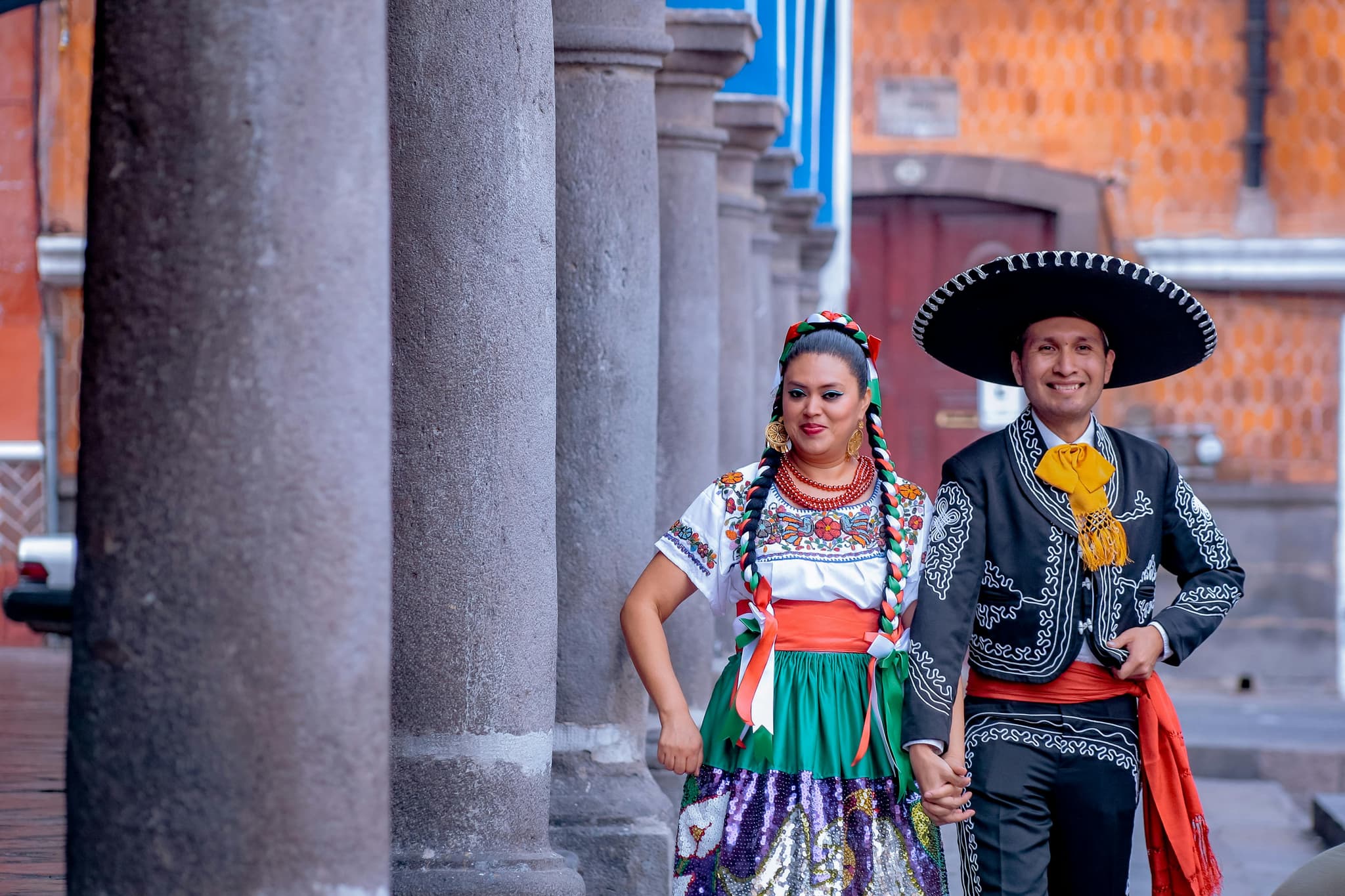 two mexican people dressed in traditional clothes