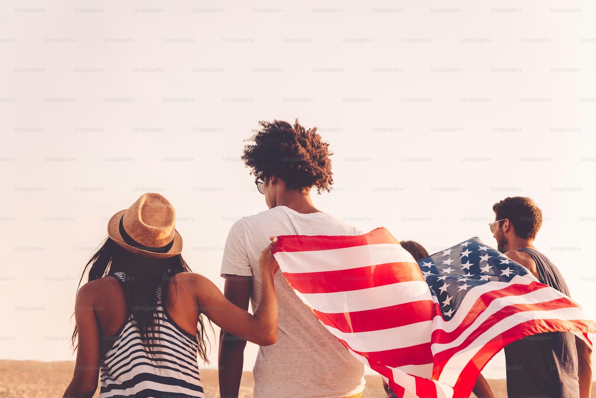 Three people holding an american flag