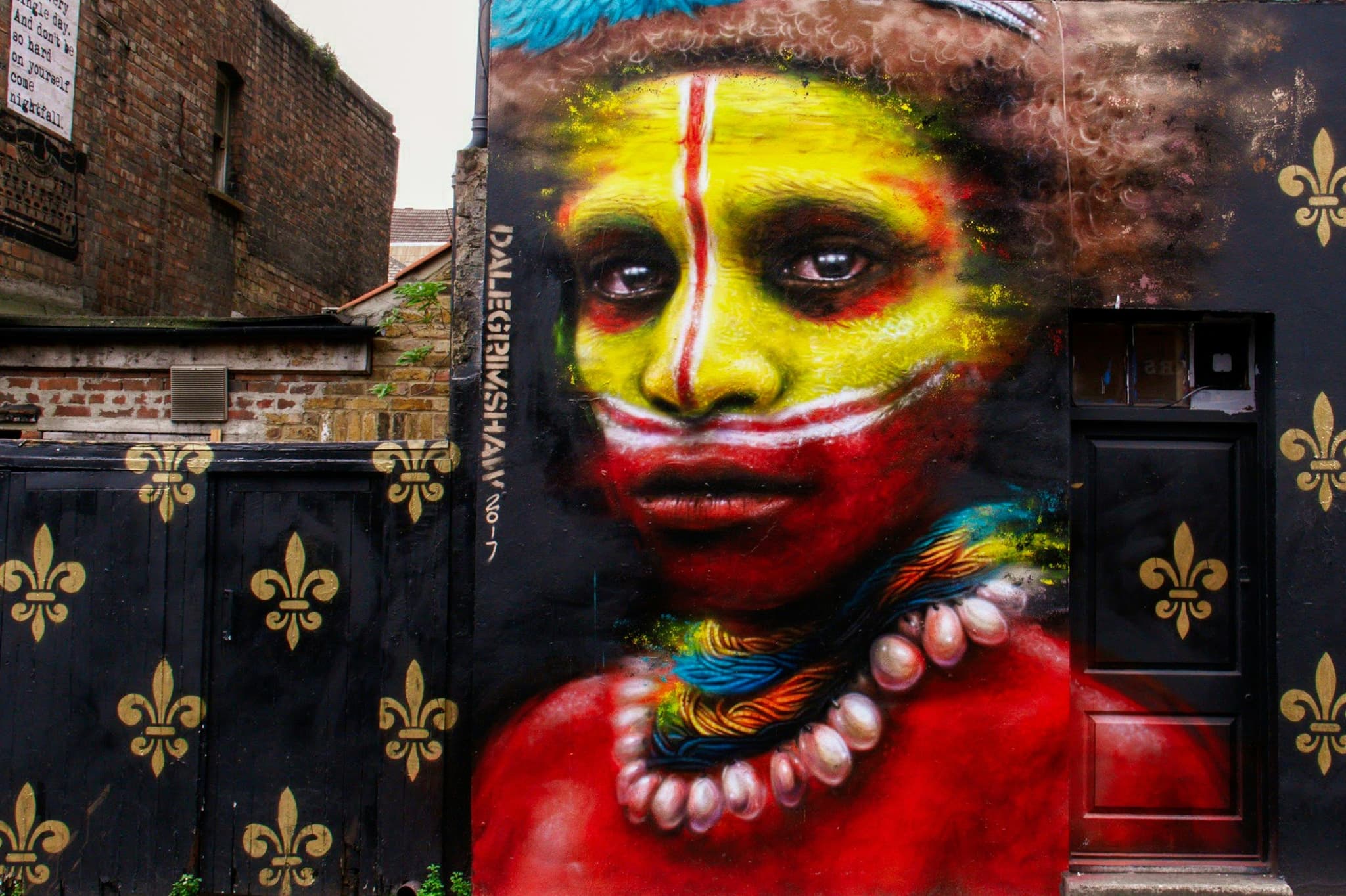 A graffiti mural of an aboriginal young boy with colorful paint