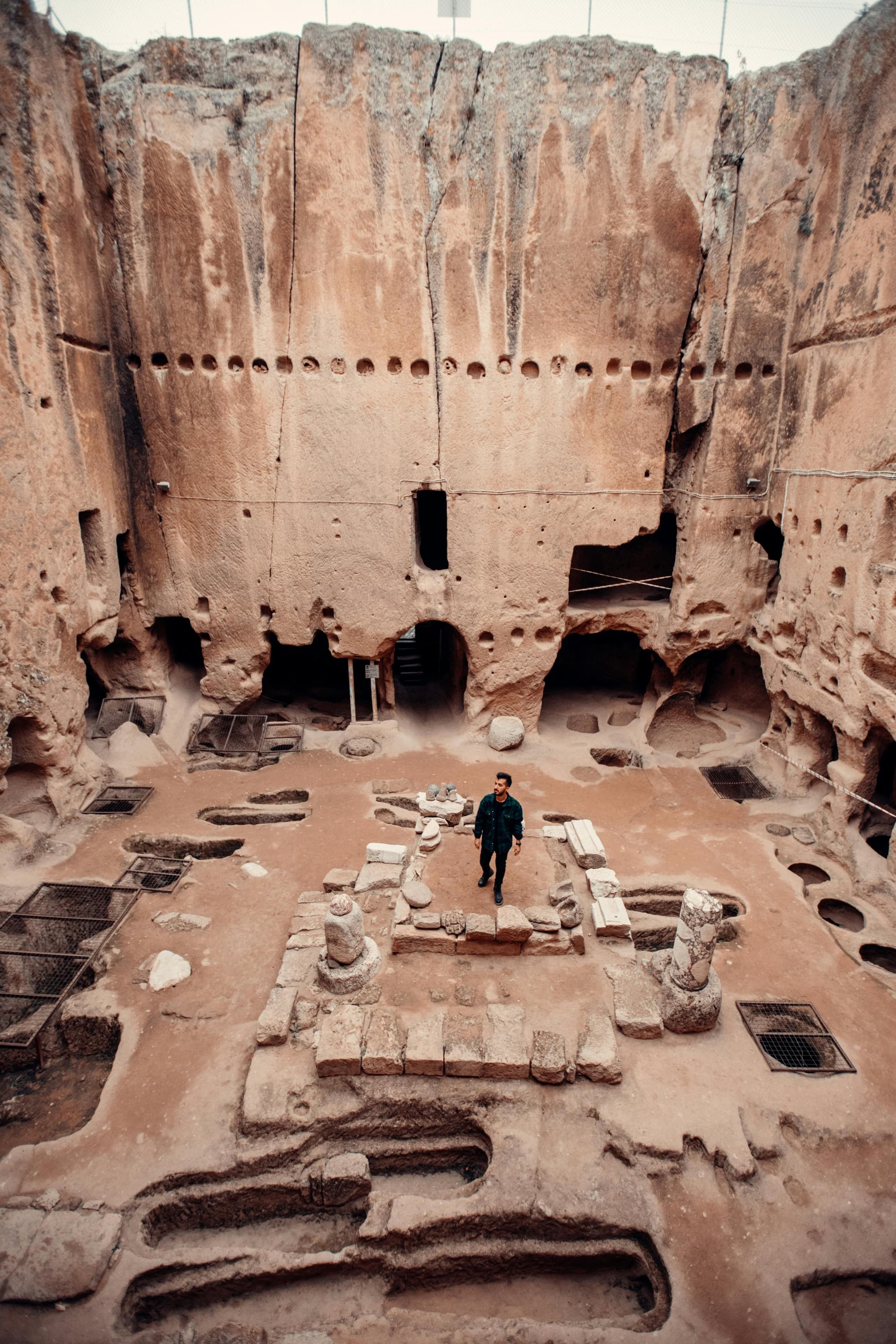 man walking in ancient ruins