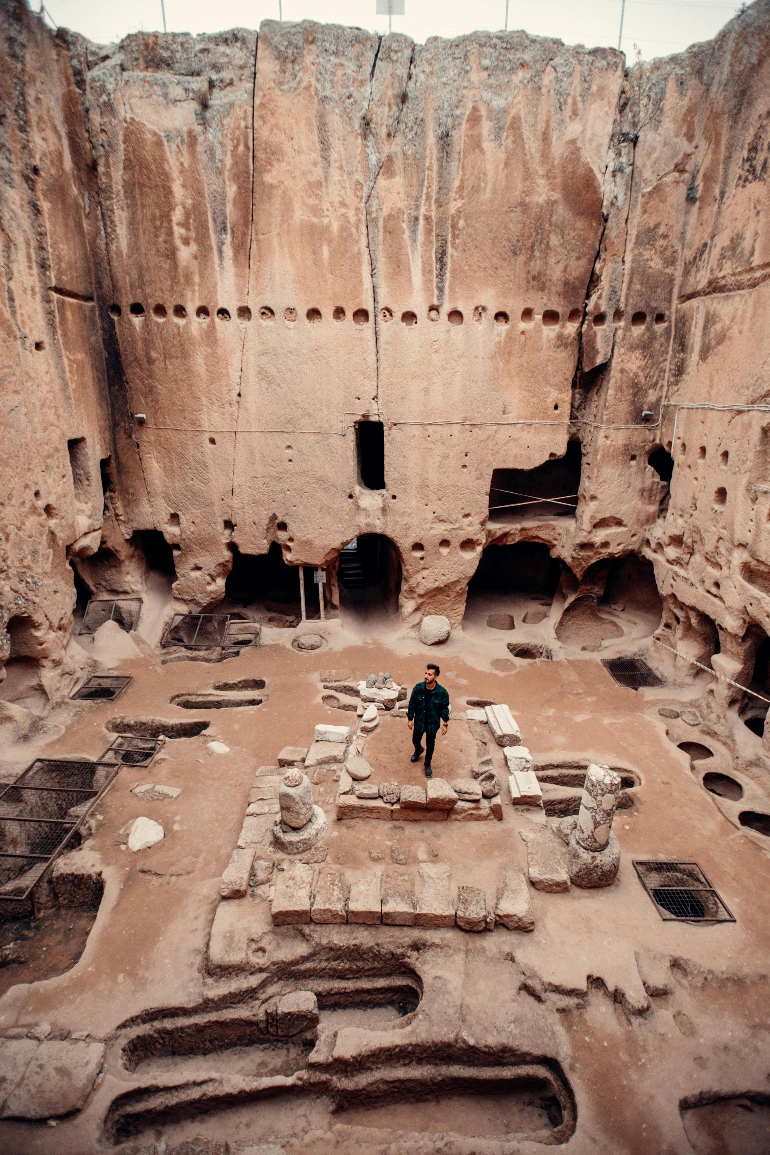 man walking in ancient ruins