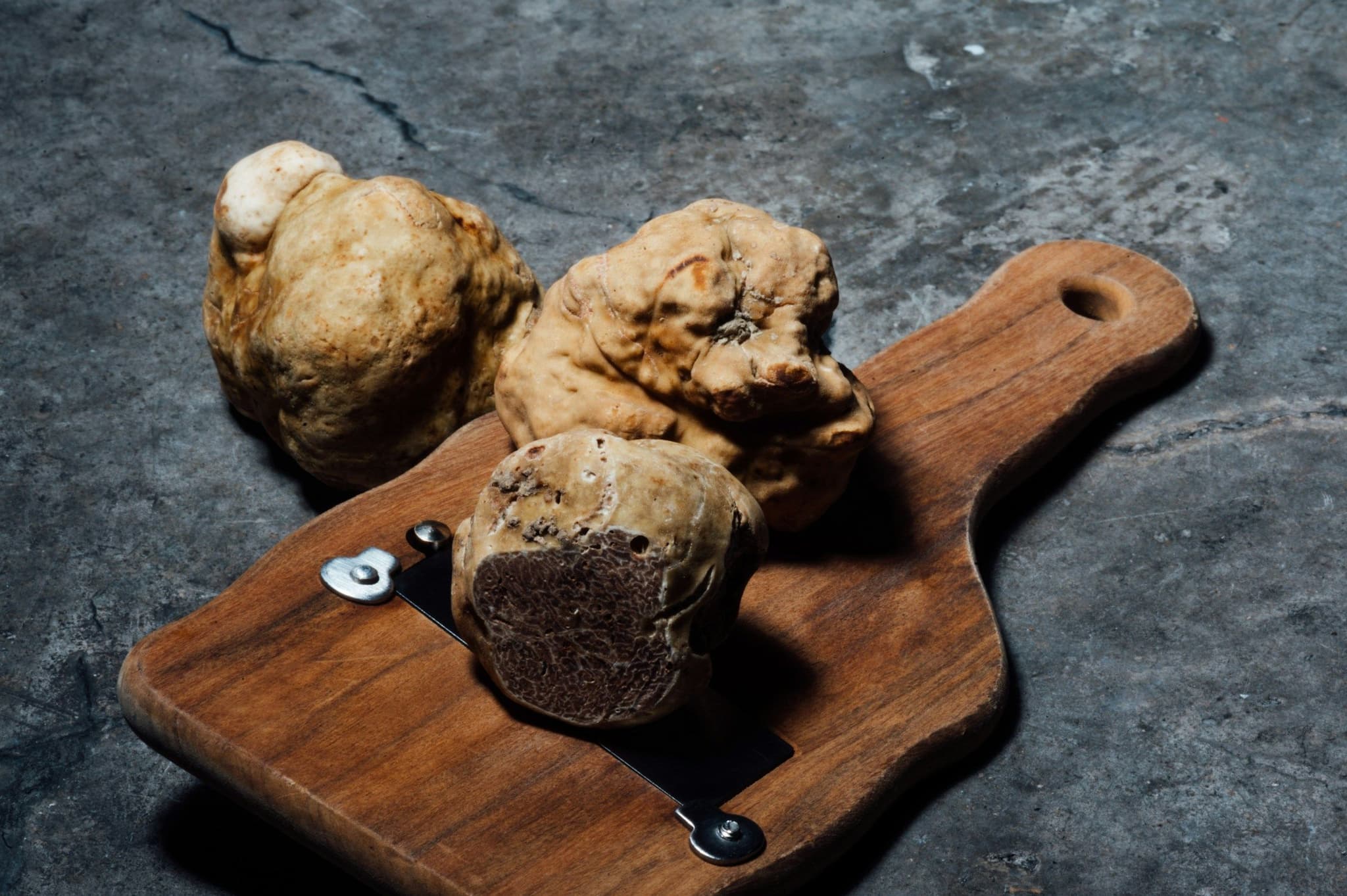 Fresh white truffles on a wooden board