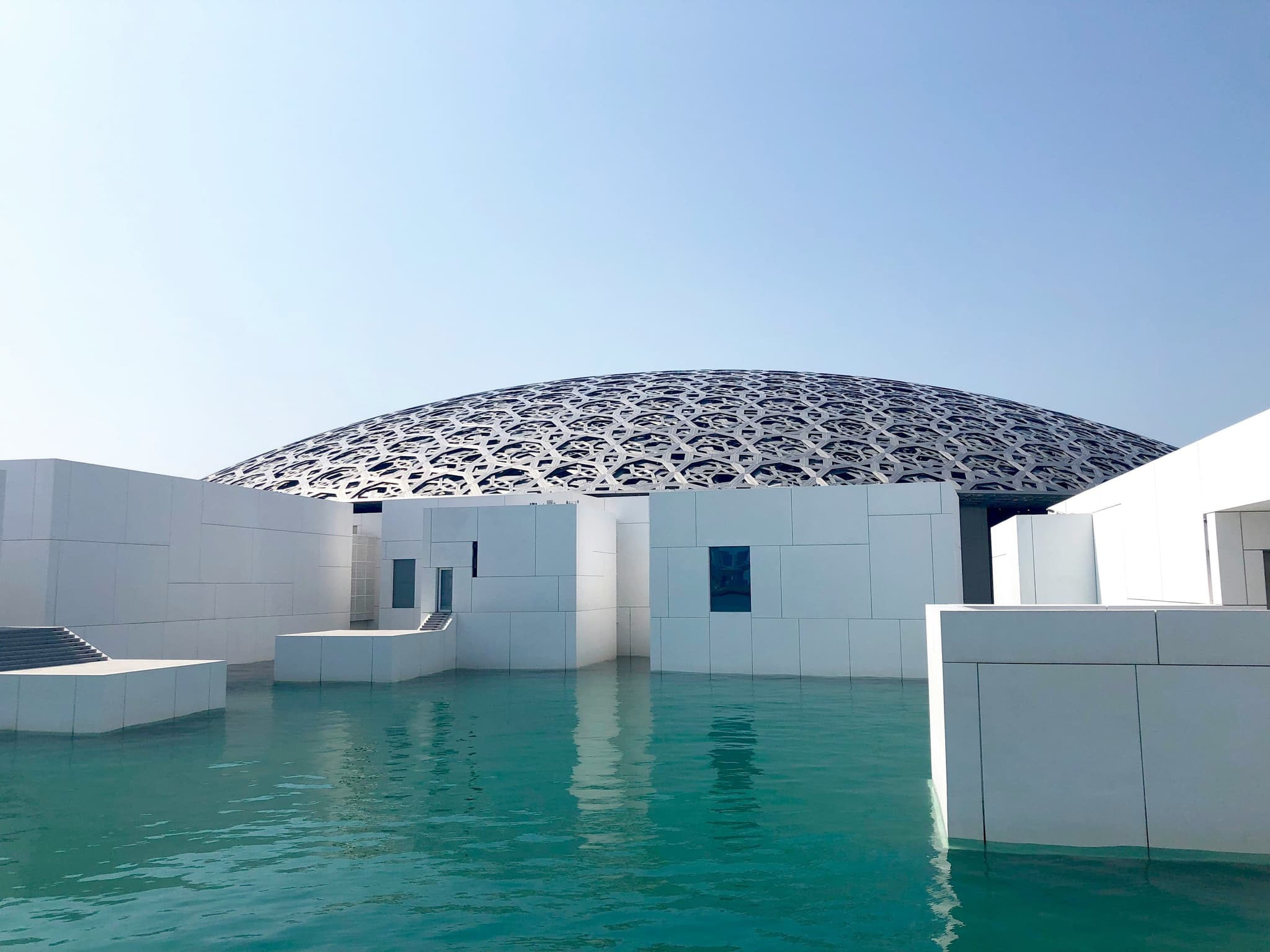 Louvre Abu Dhabi white building with white walls and pool