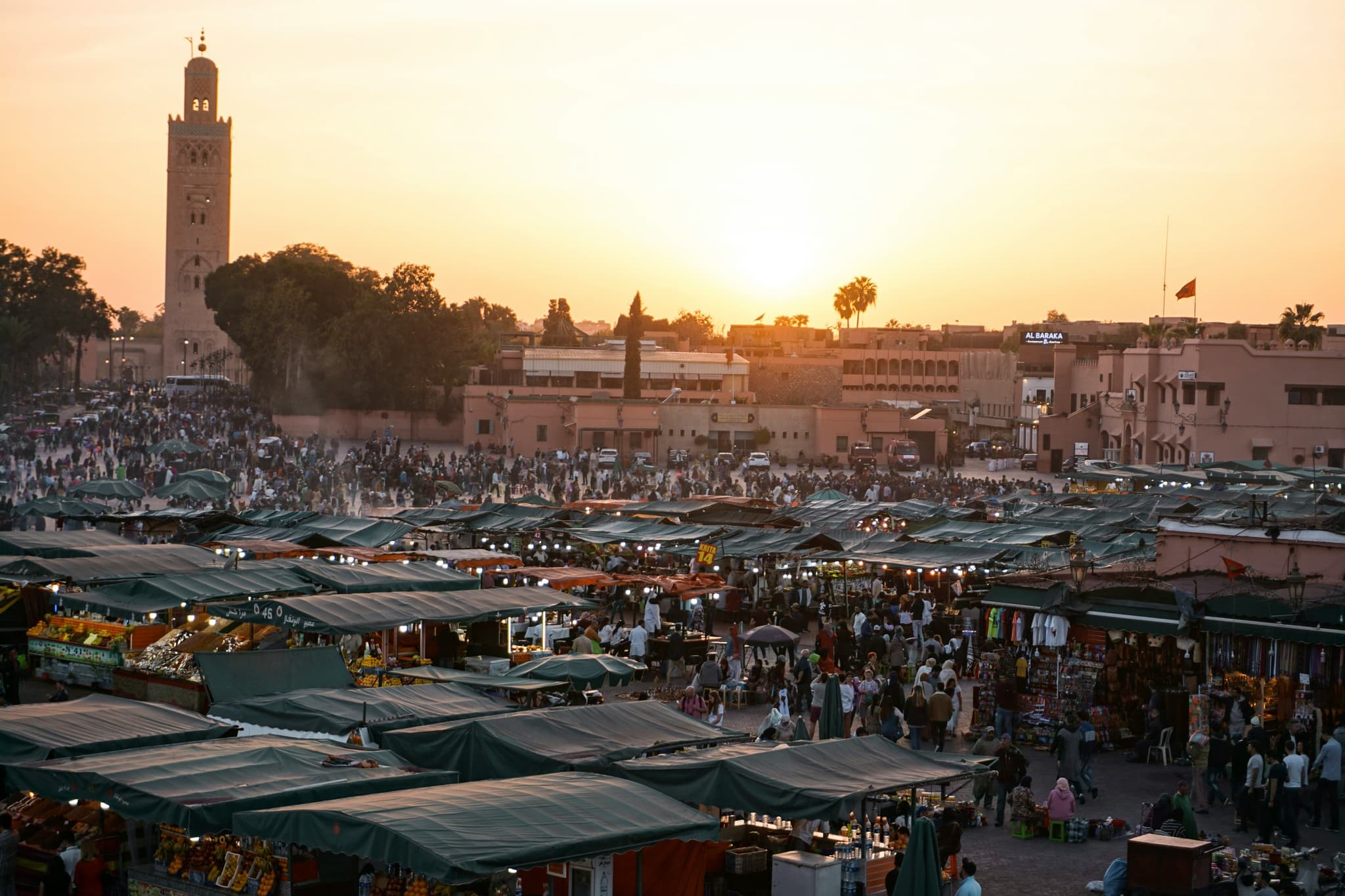 Busy city square and market from above during sunset in marrakech