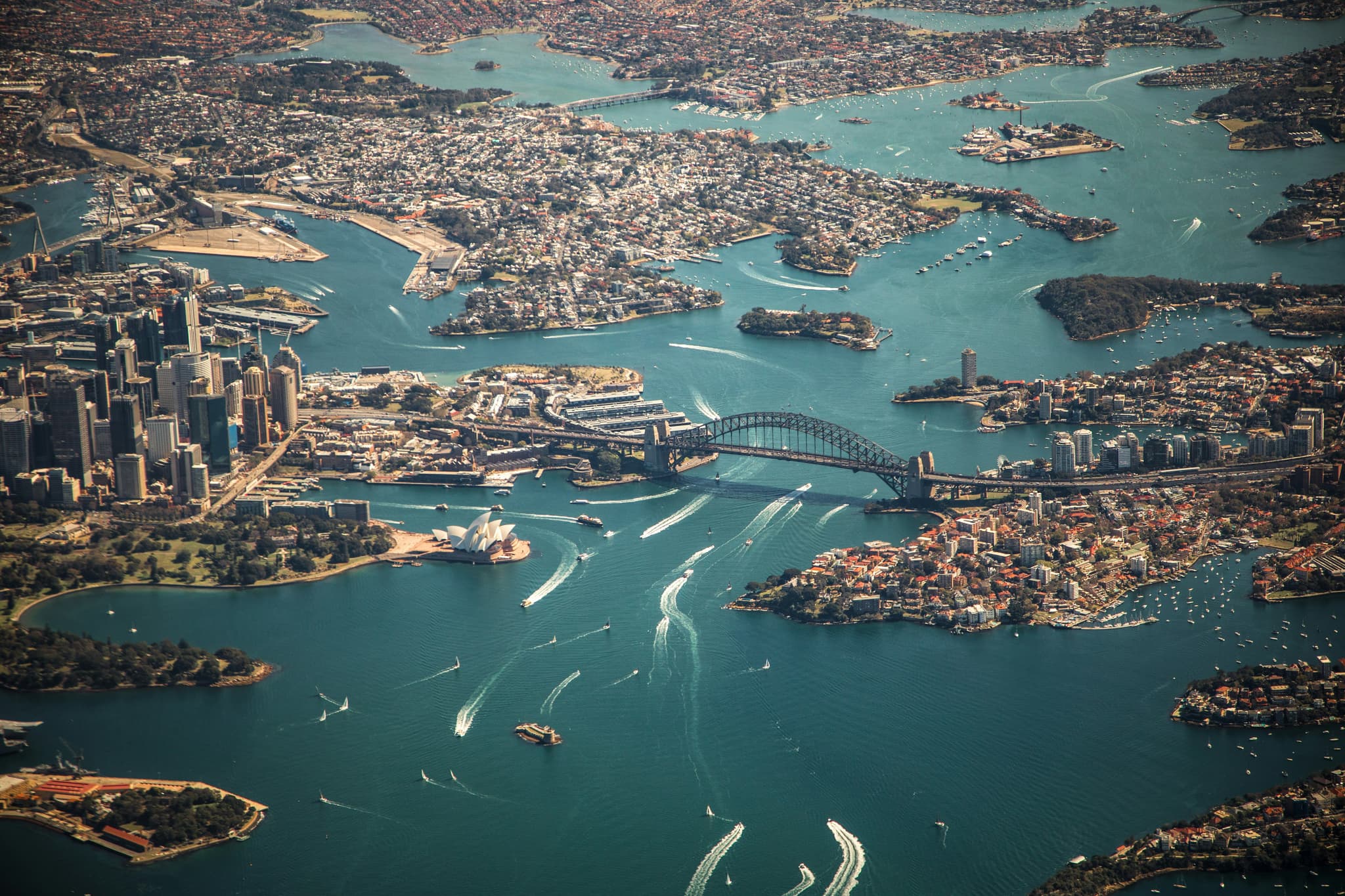 Aerial view of Sydney with islands of city on blue water