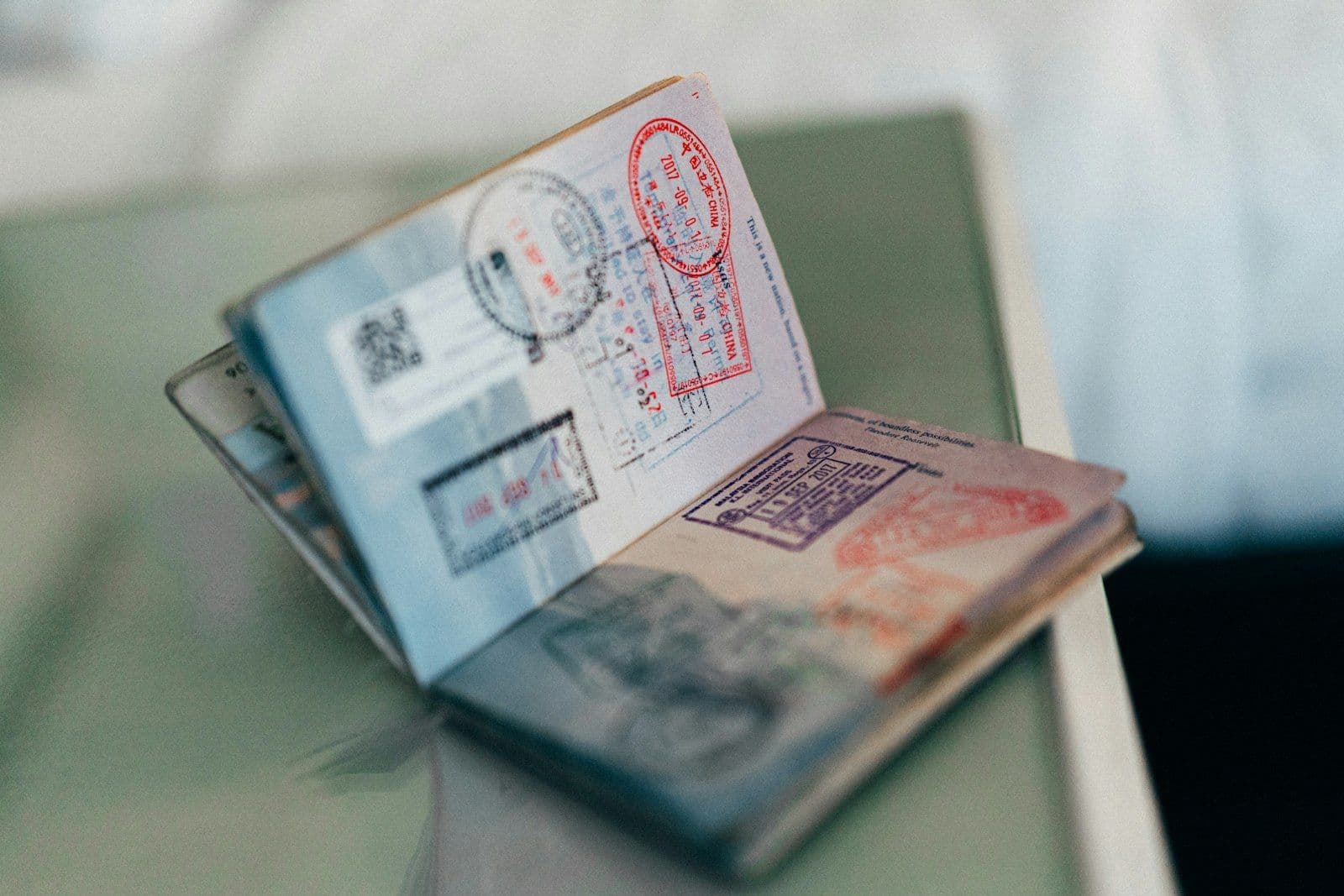 An open passport page covered in colorful entry and exit stamps