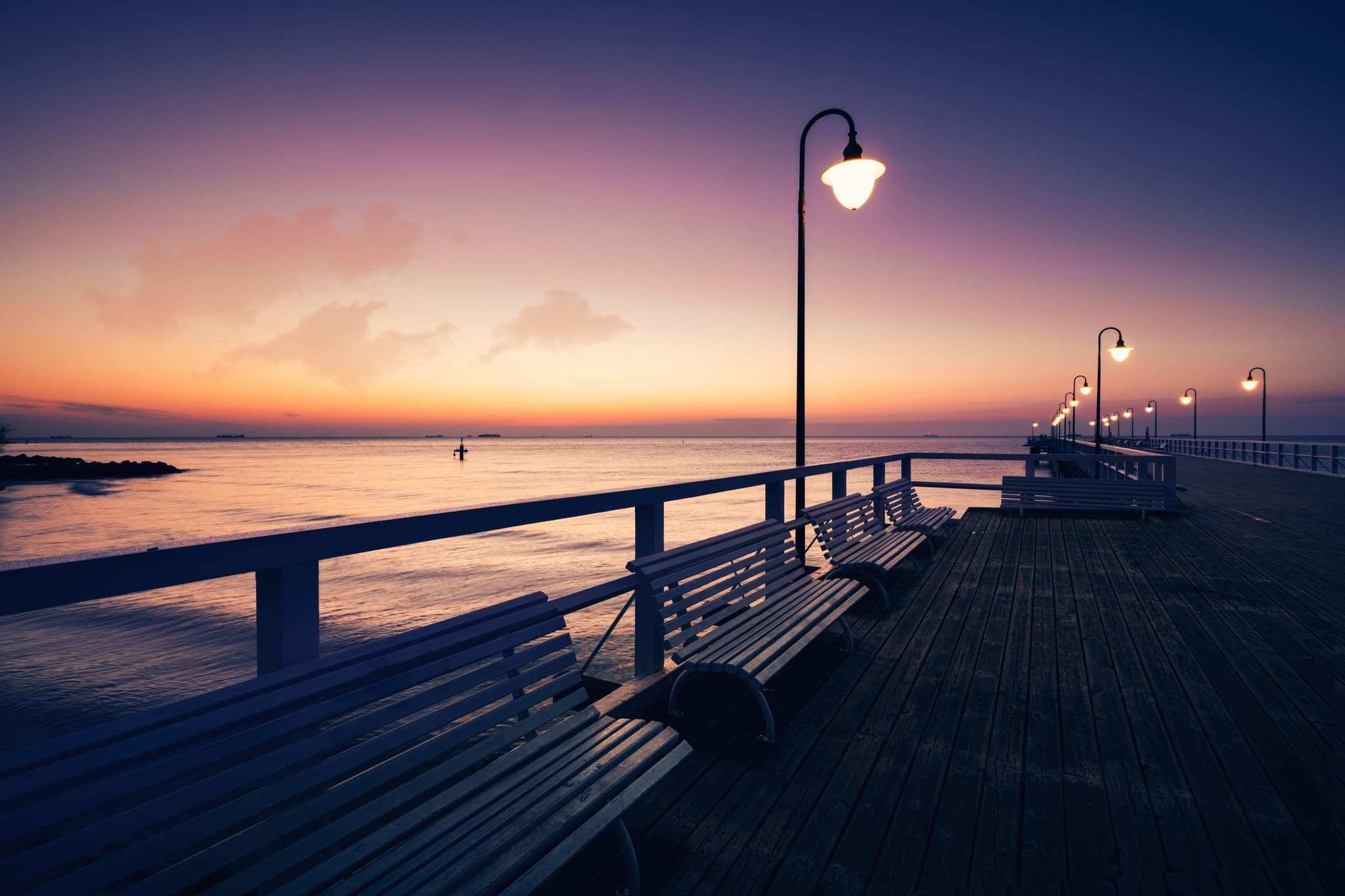 Baltic sea and benches around it at sunset