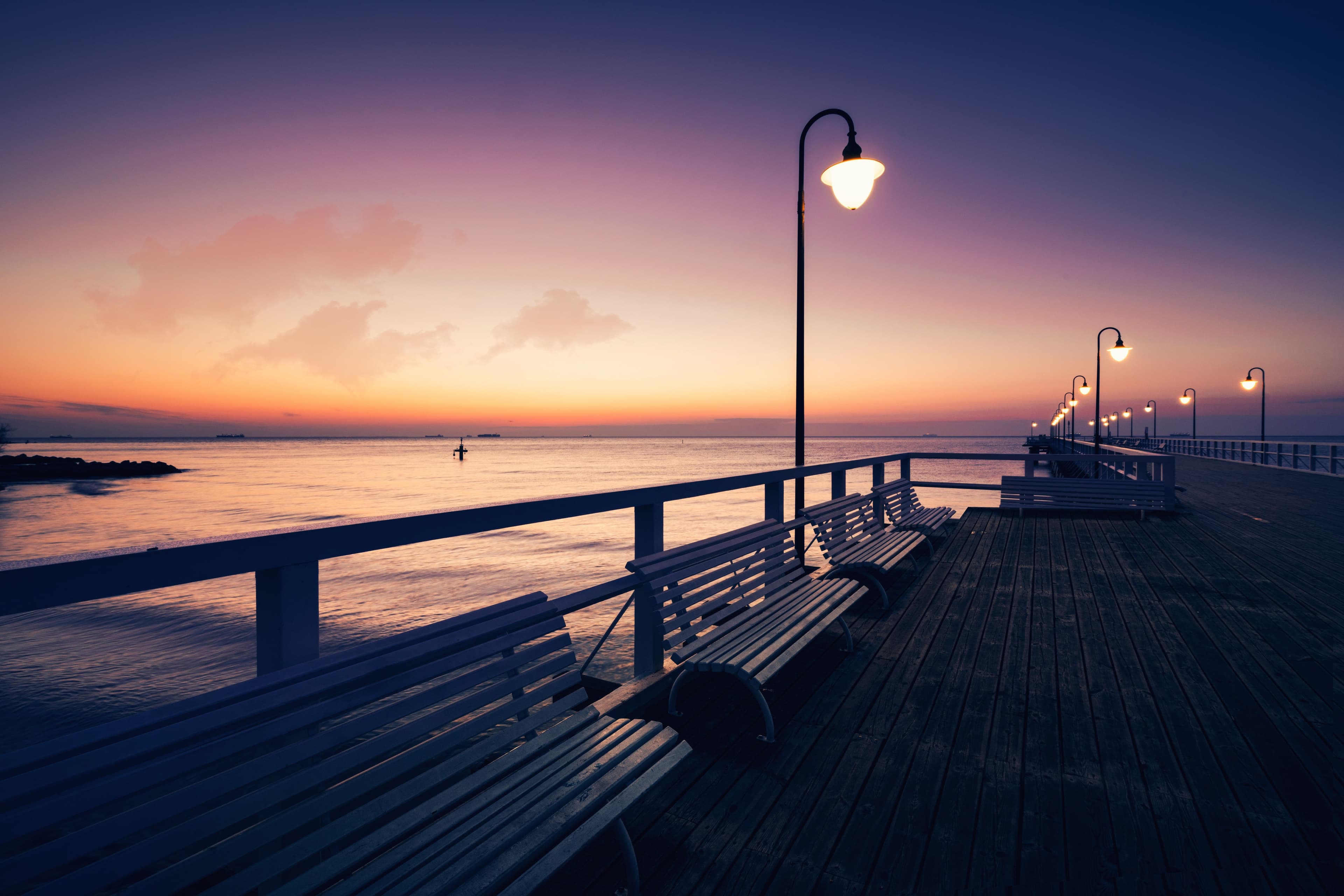 Baltic sea and benches around it at sunset