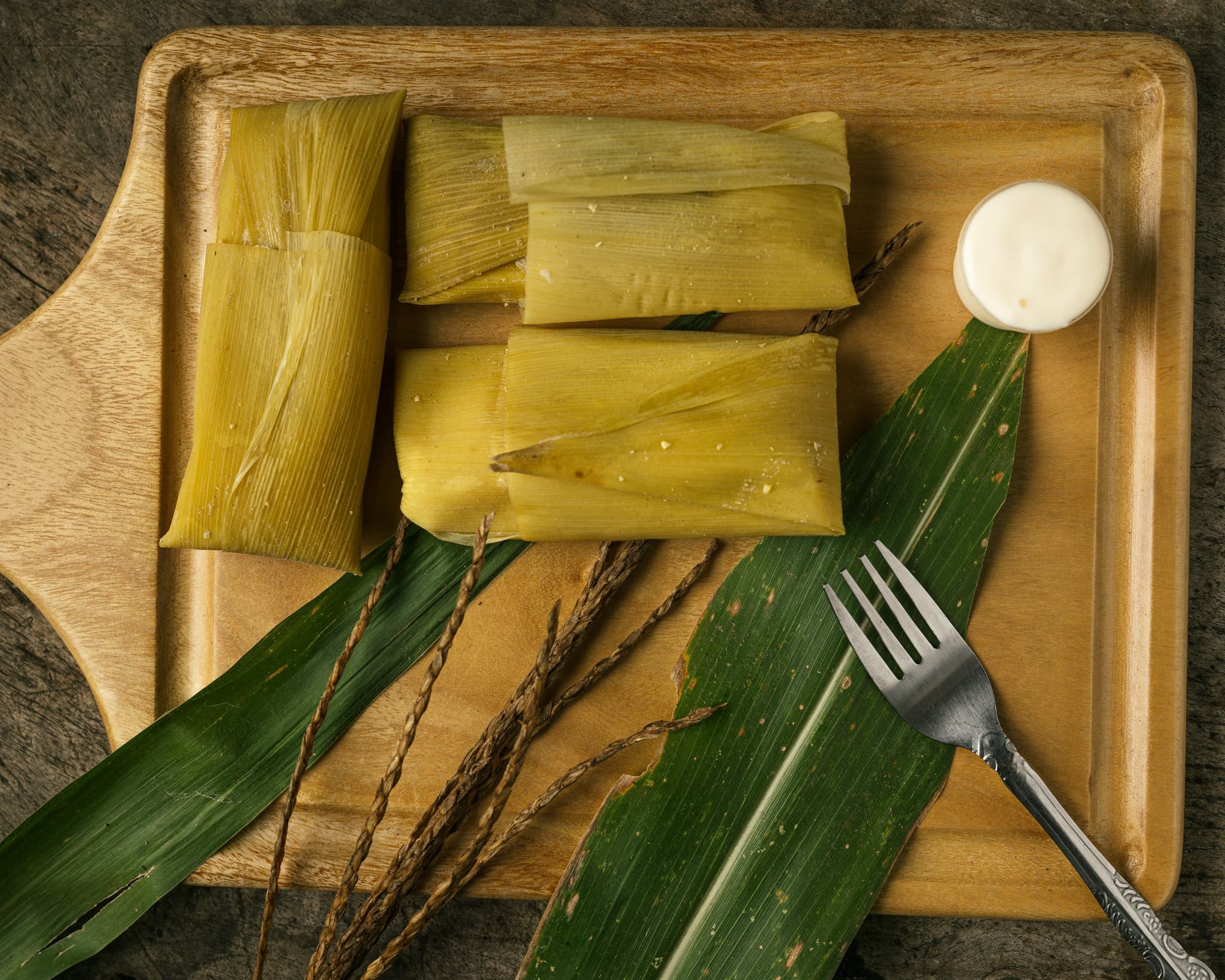 tamales on a wooden cutting board