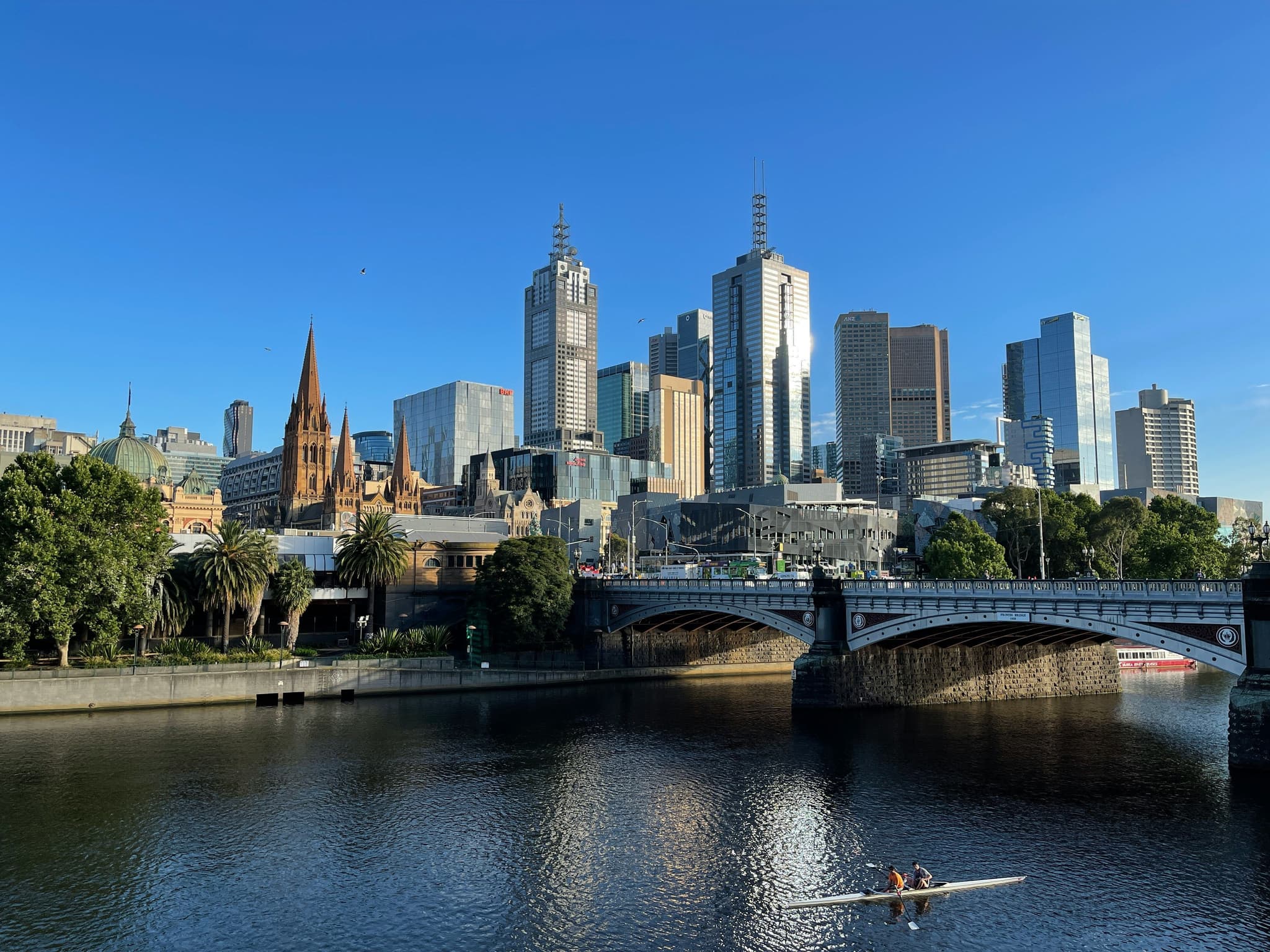 River and bridge in Melbourne, blue sky and skyscrapers in background