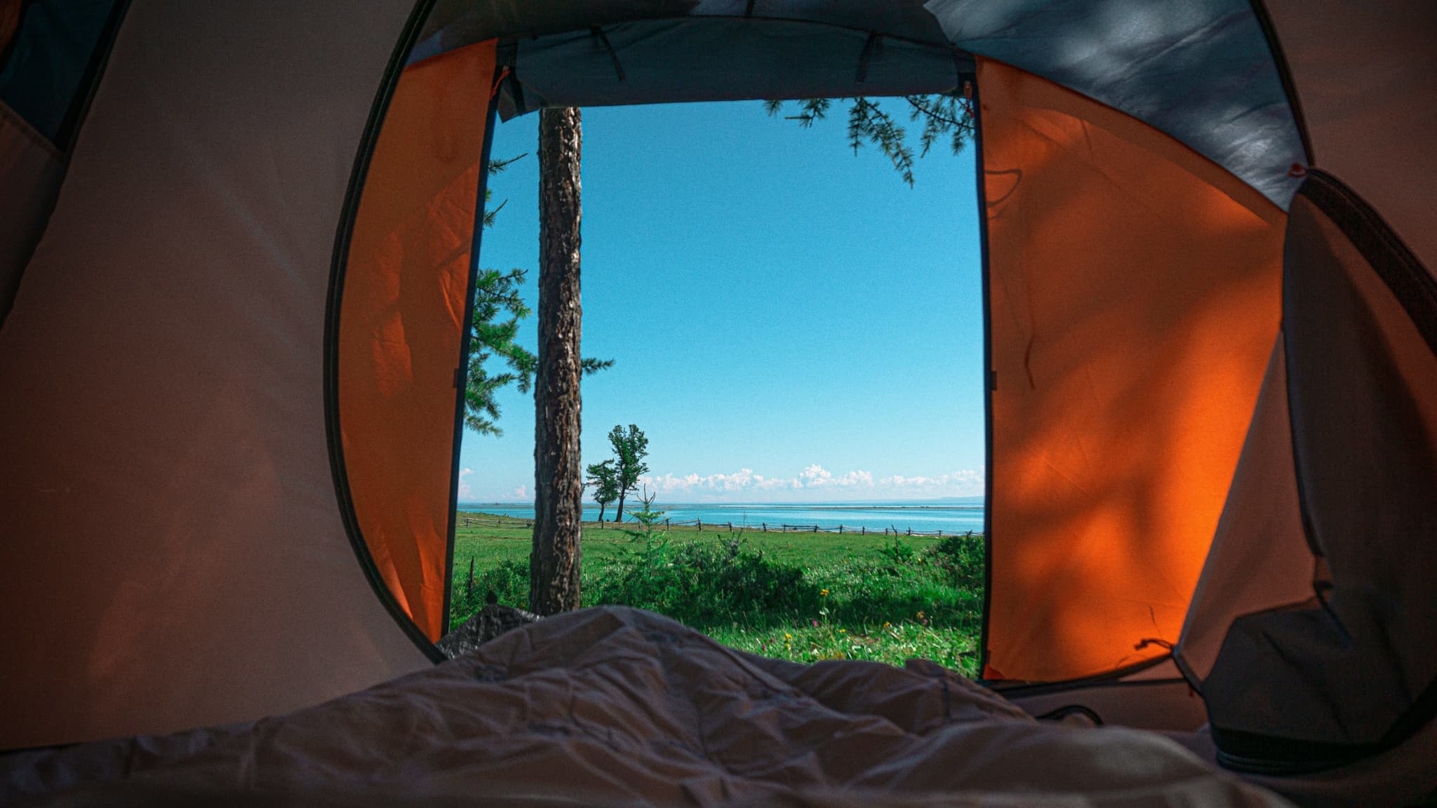 The inside of a tent pitched beside a calm Swedish lake