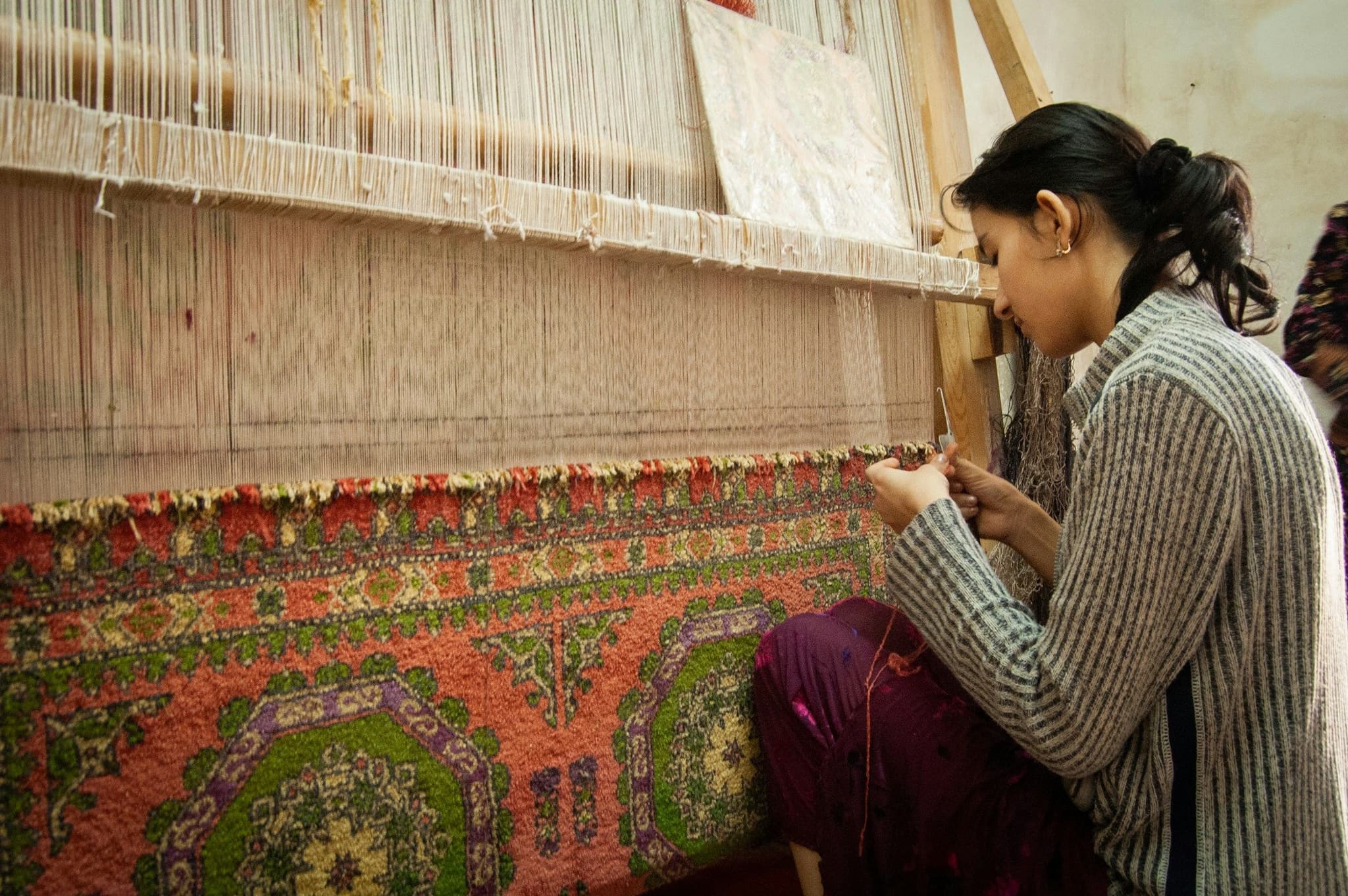 A weaver working at a hand loom