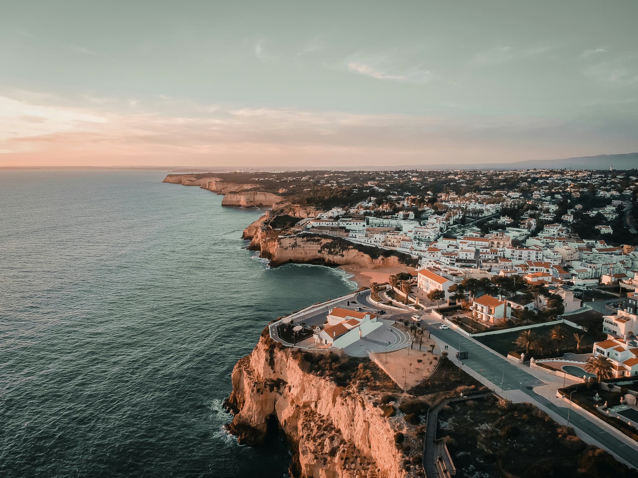 Portimão cliff with houses and sea from above during sunset evening