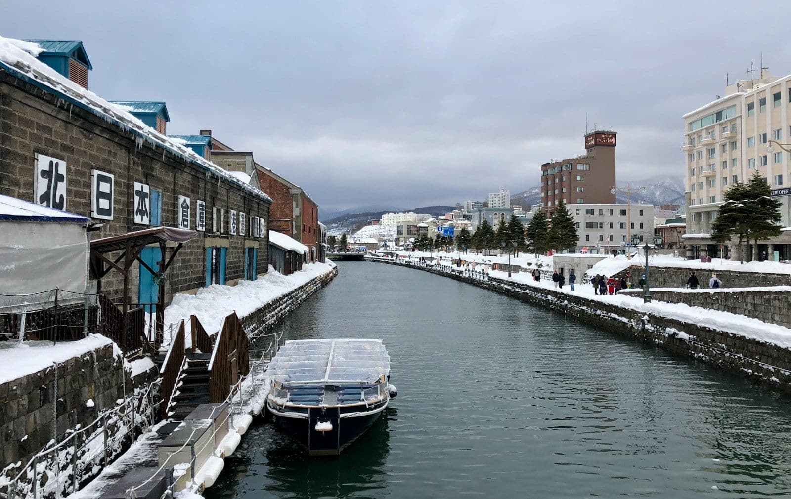 Boats moored along Otaru Canal in Hokkaido, Japan, lined with its historic waterfront buildings.