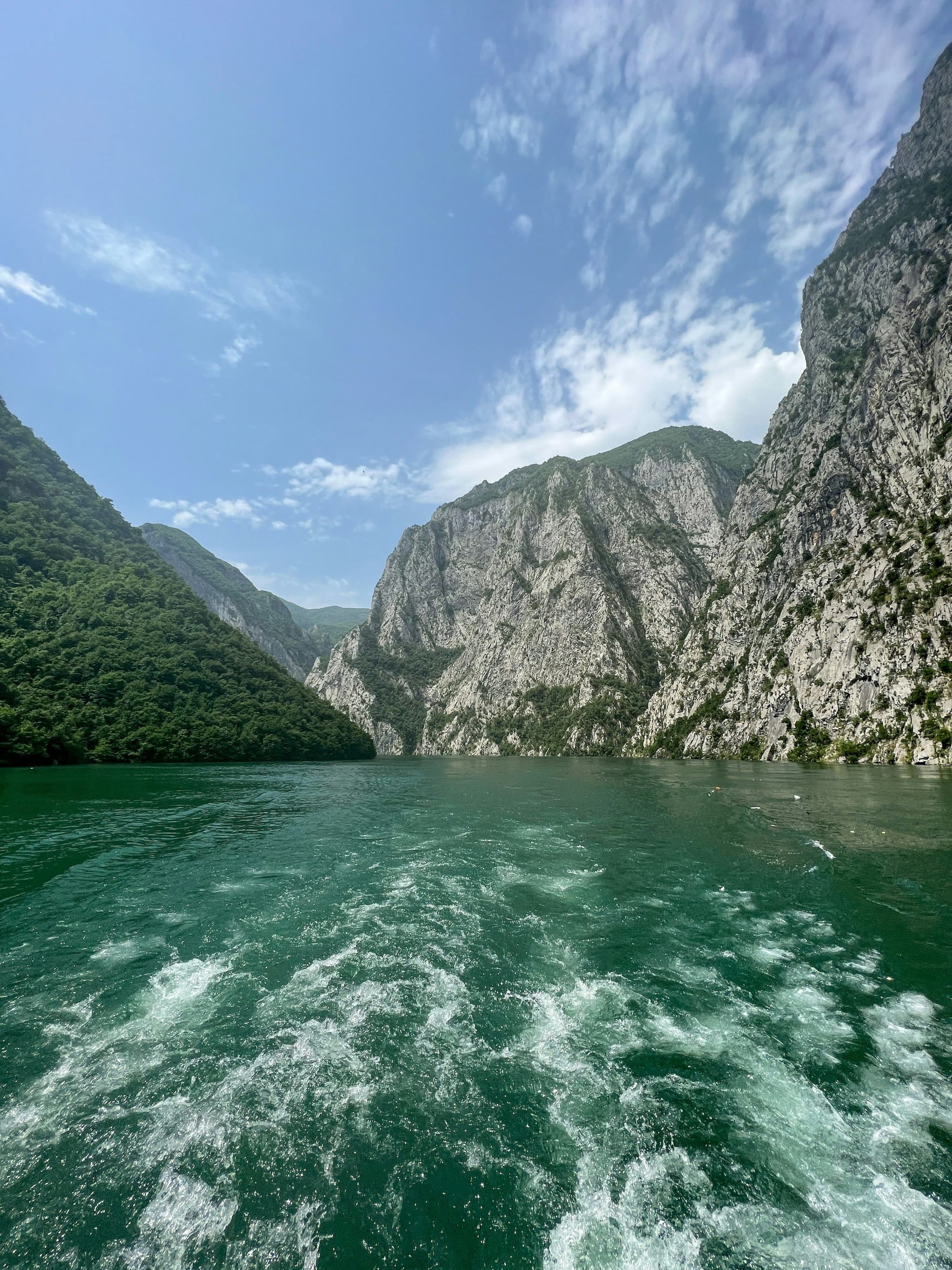Lake Koman and steep mountains seen from a boat