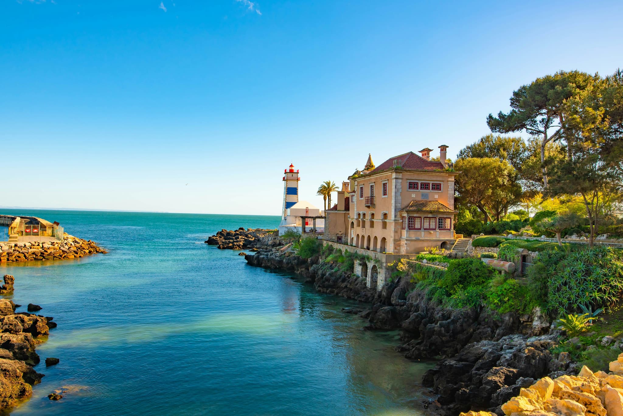 Trees and colorful house along the coast of Portugal