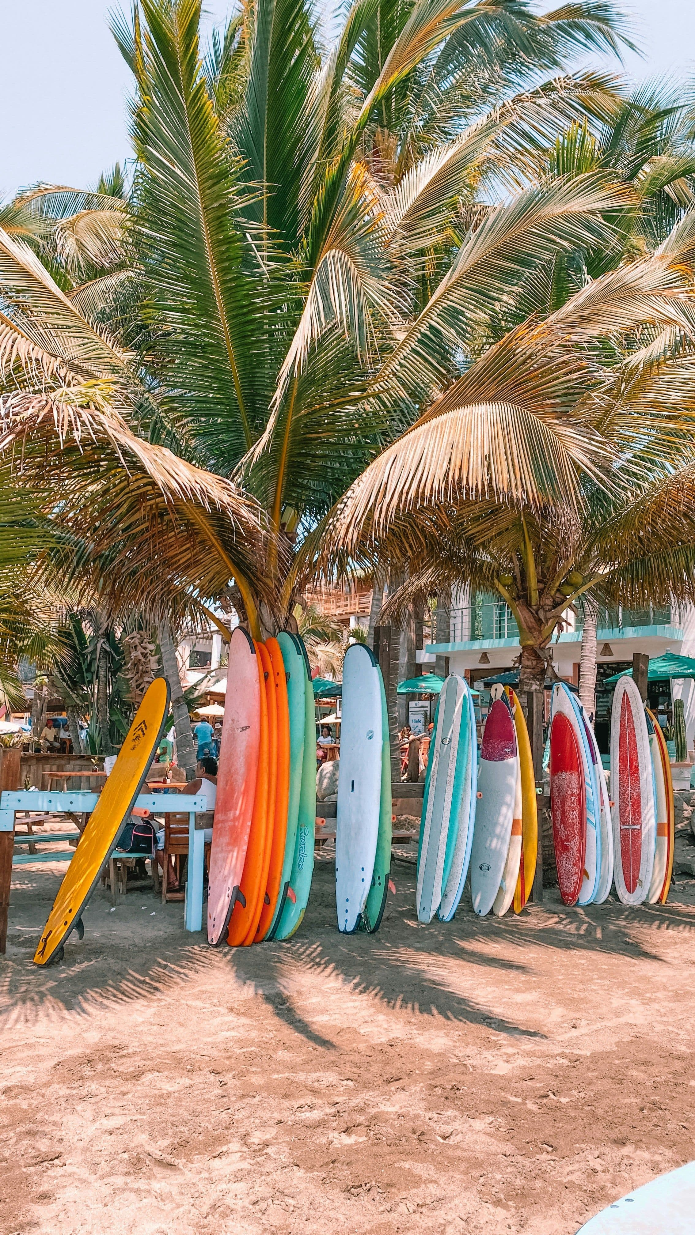 surfboards stacked on the beach