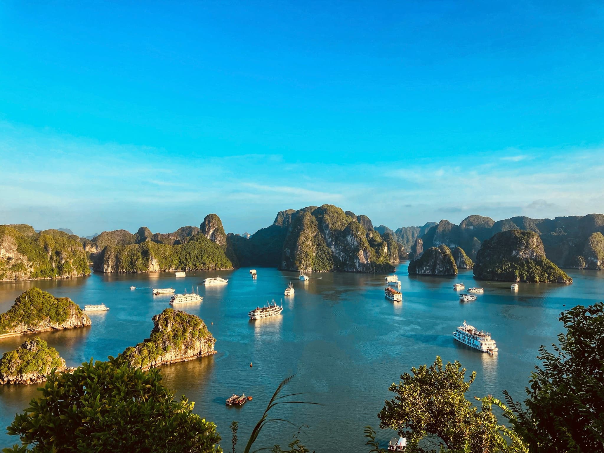 Ha long bay water and cliffs and boats on a clear day