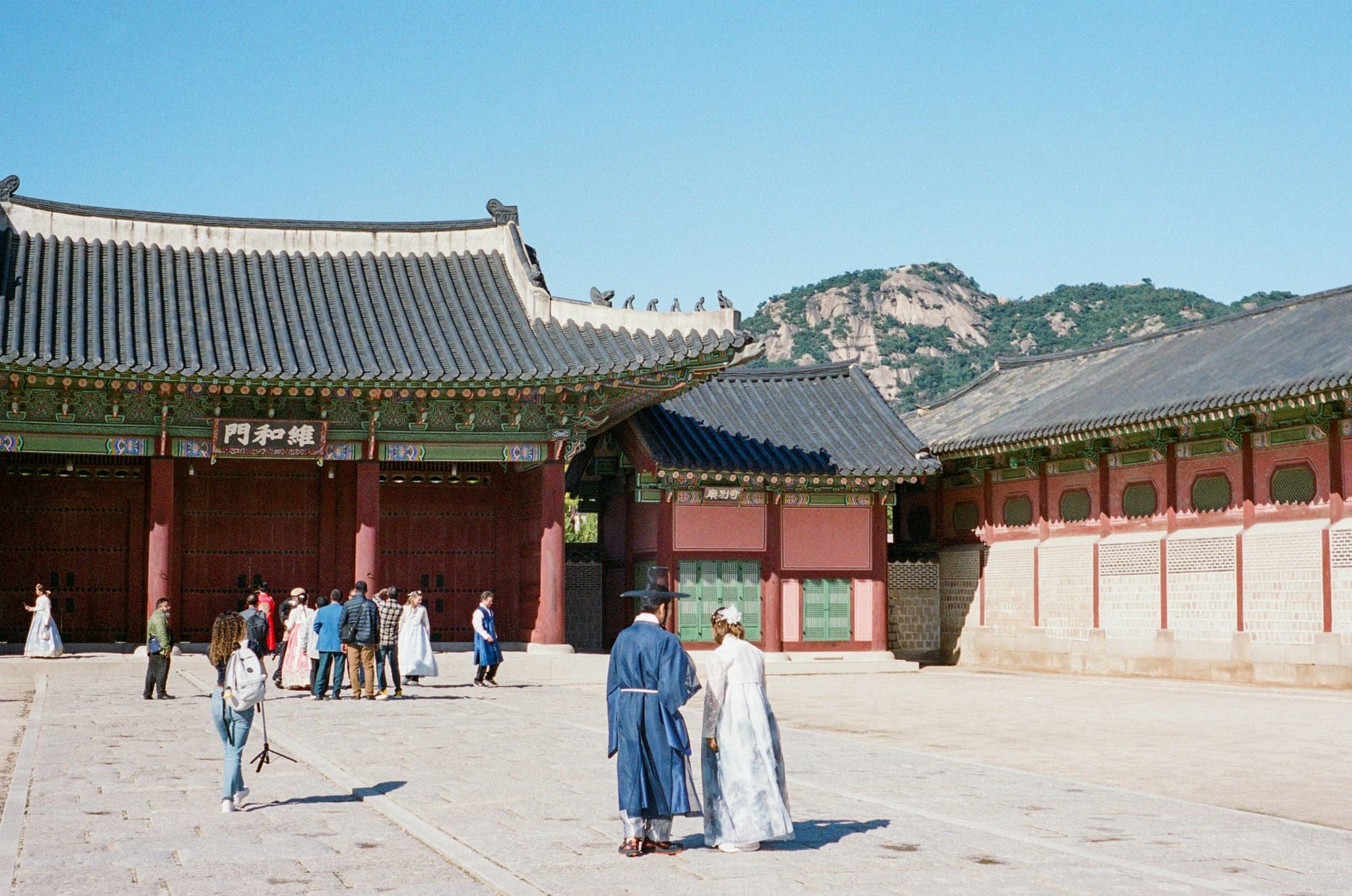 Monks and visitors in front of a Korean temple