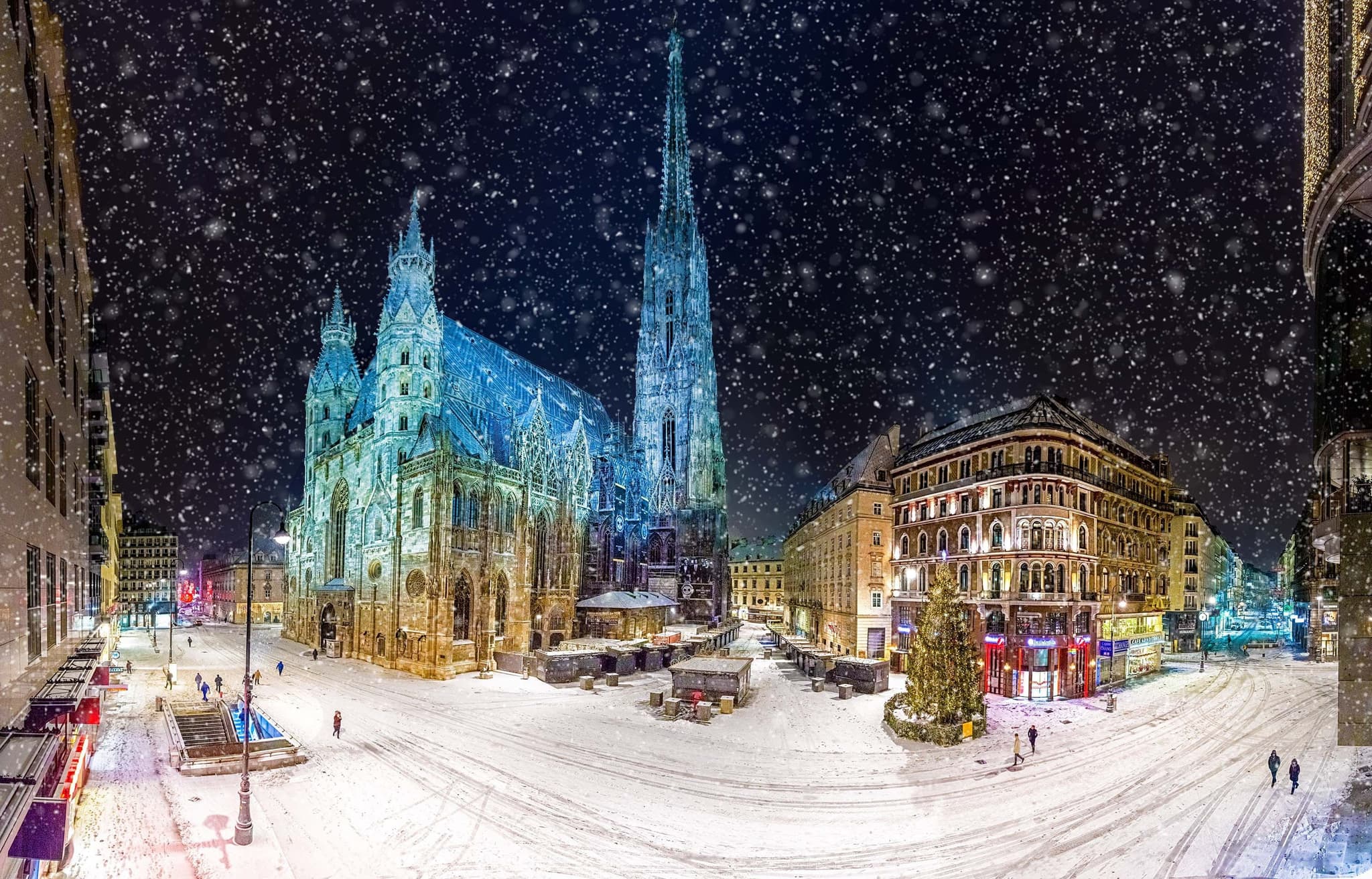 Winter city snow covered with cathedral lights during the night in december