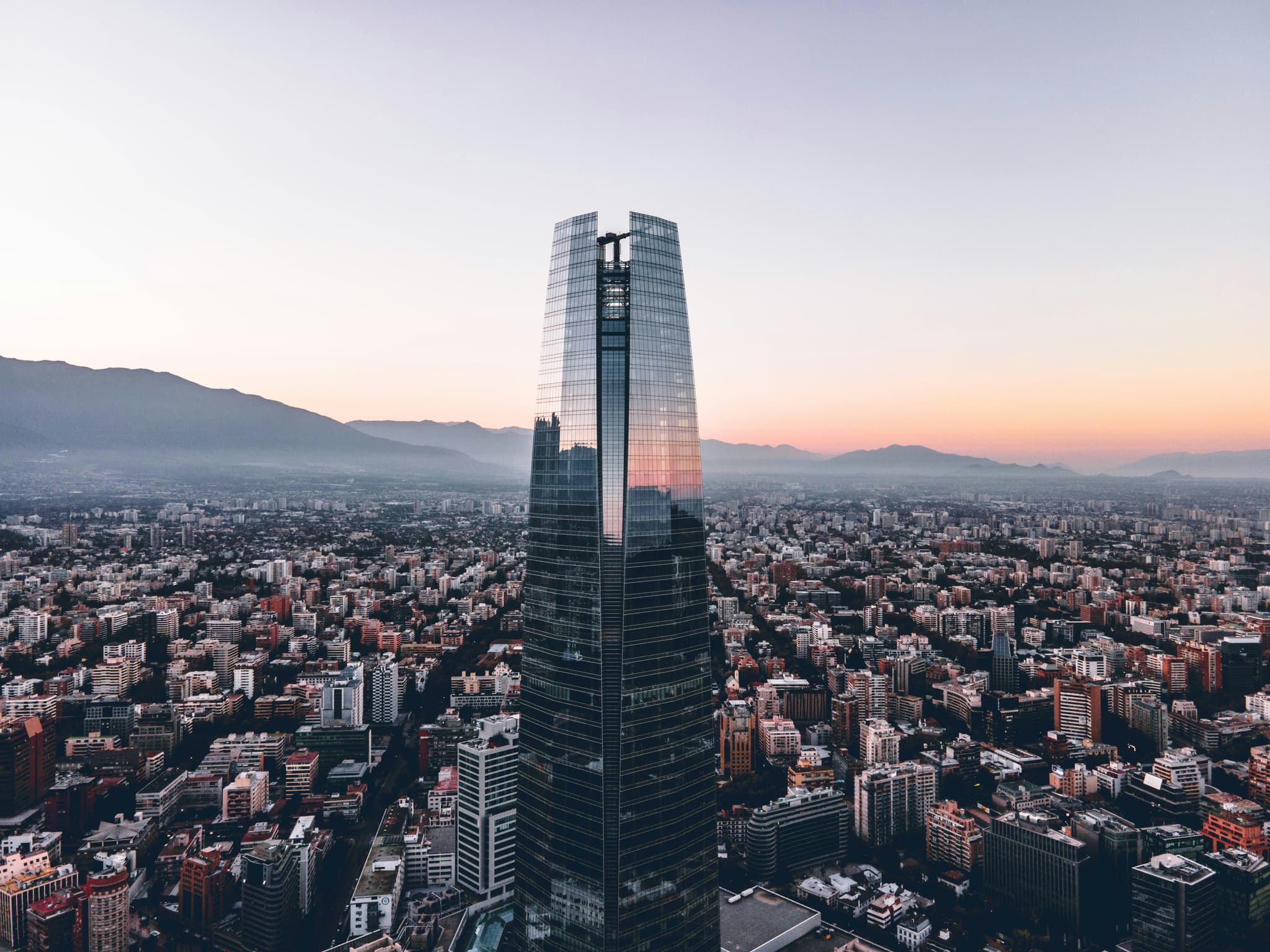 Skyscraper in Santiago during sunset with city below