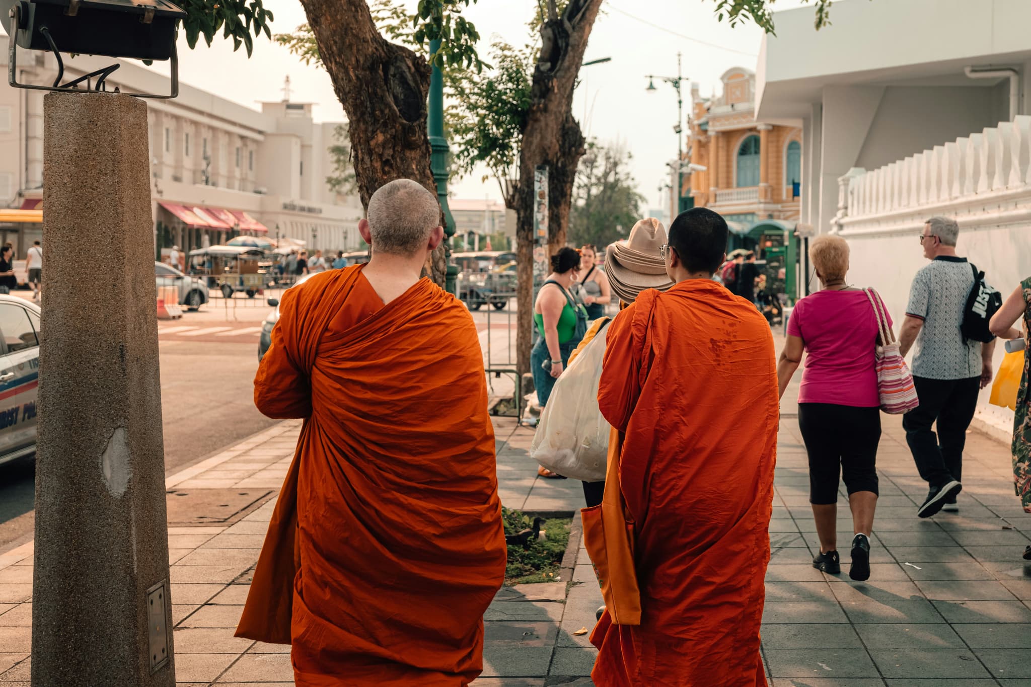 Buddhist monks walking in public in street in thailand