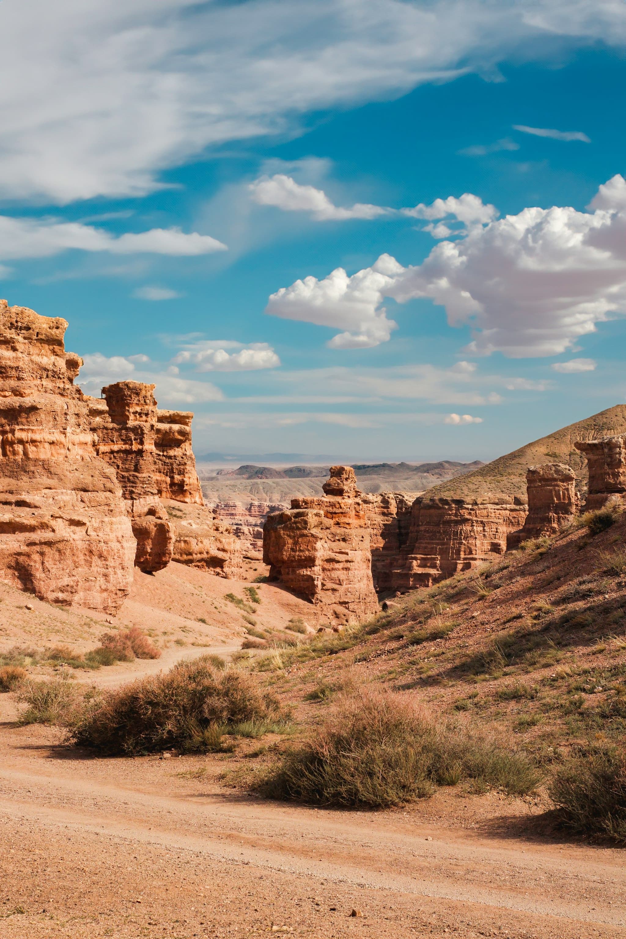 A dirt track running between red rock walls in Charyn Canyon