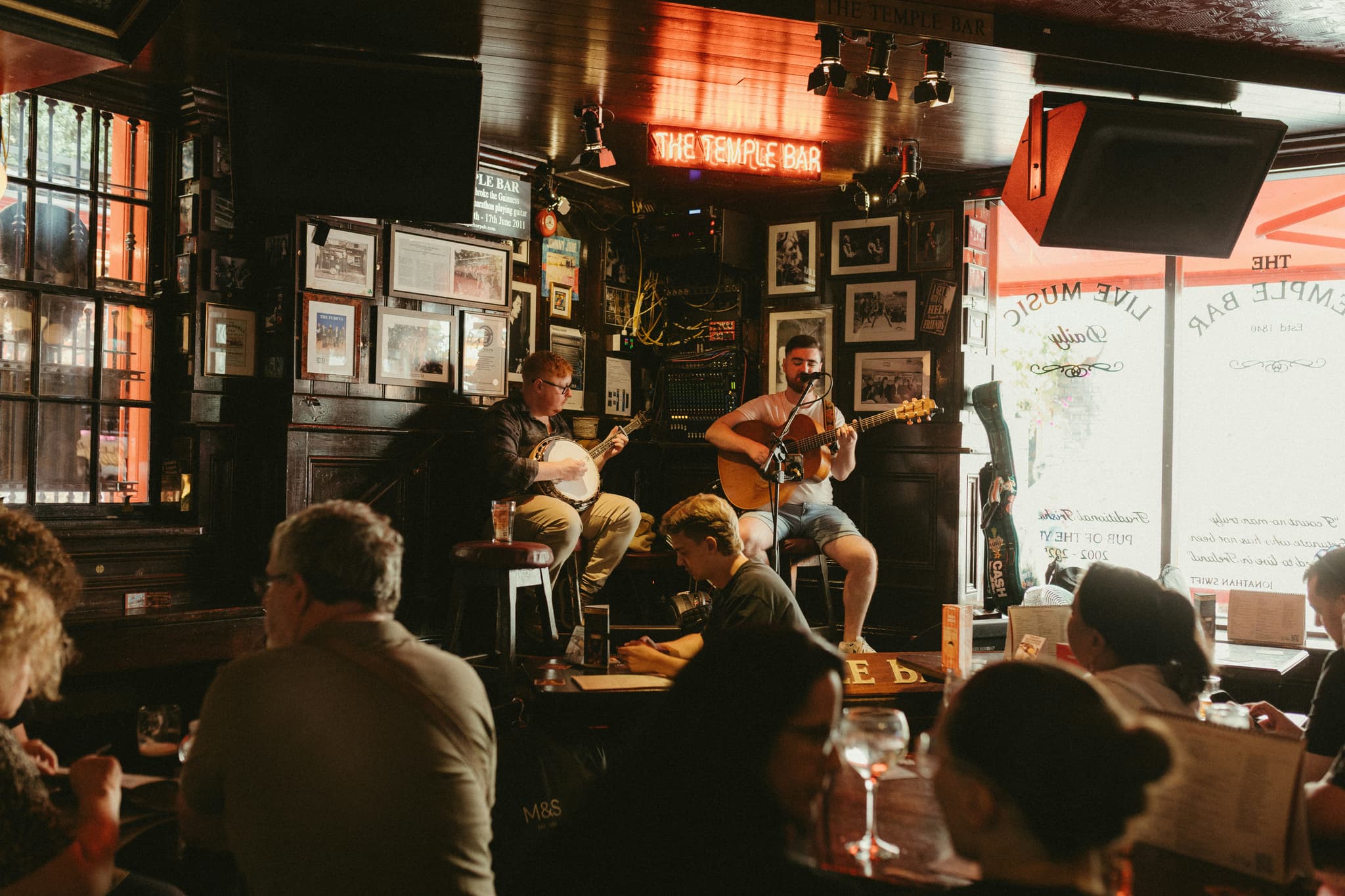 Musicians playing a traditional music session in a small Irish pub