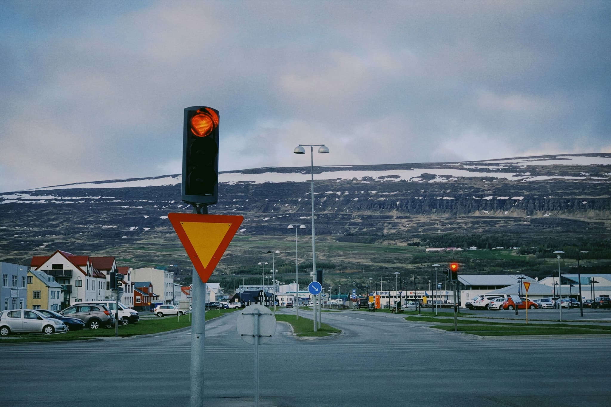 Akureyri town centre with heart shaped traffic light with mountains in the background, north Iceland