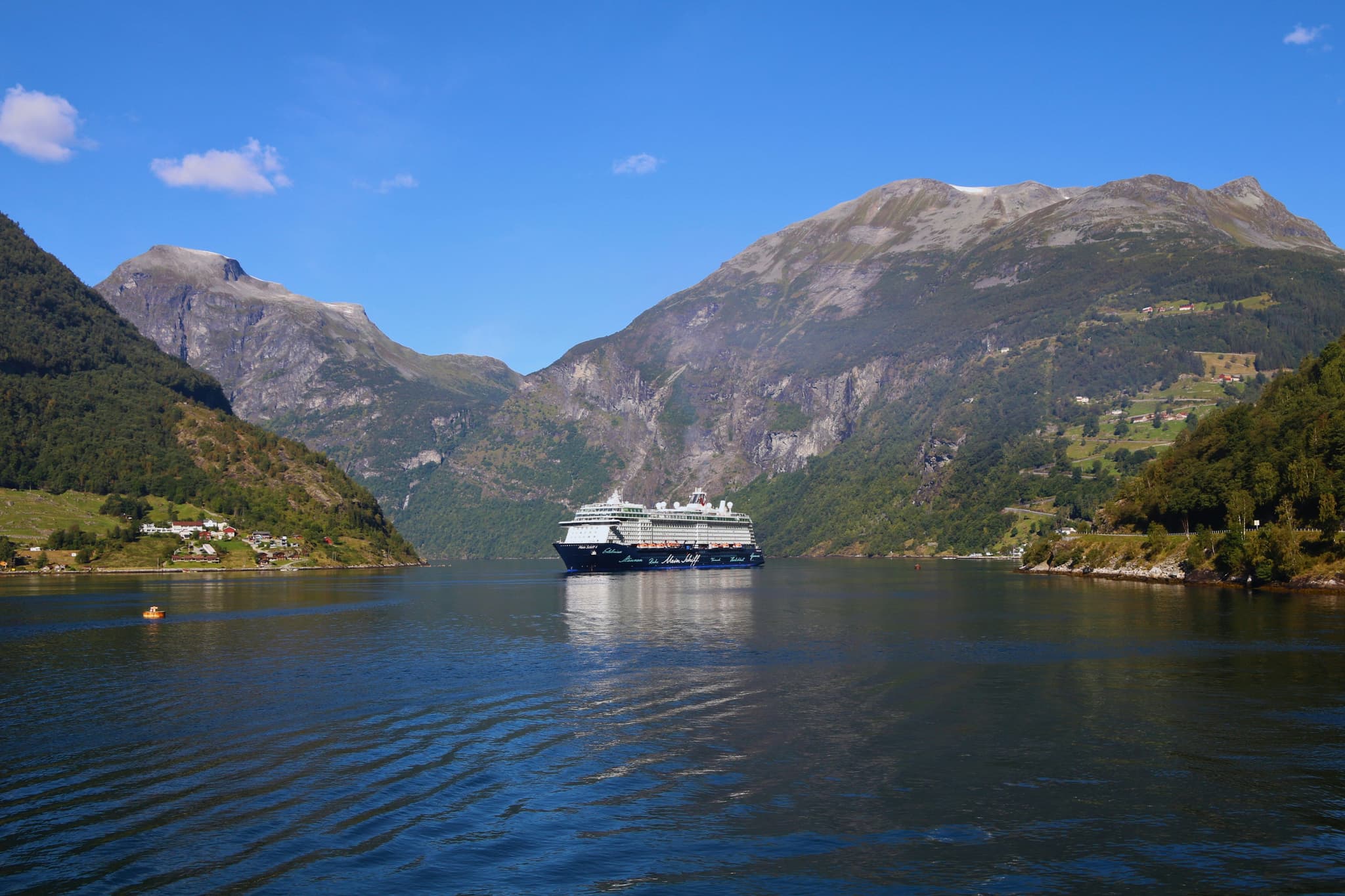 Cruise ship on the river between the mountains of Geirangerfjord