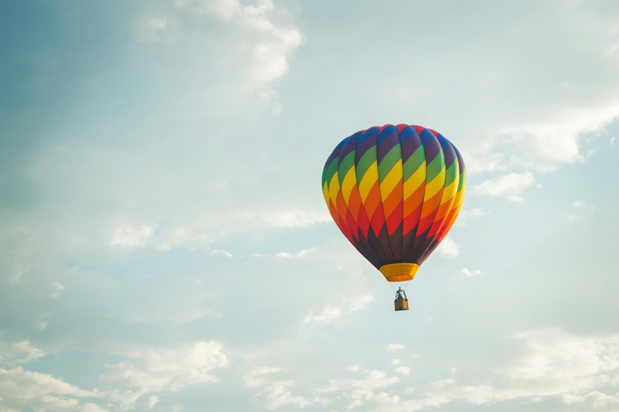 Hot air balloon with color pattern in the light sky